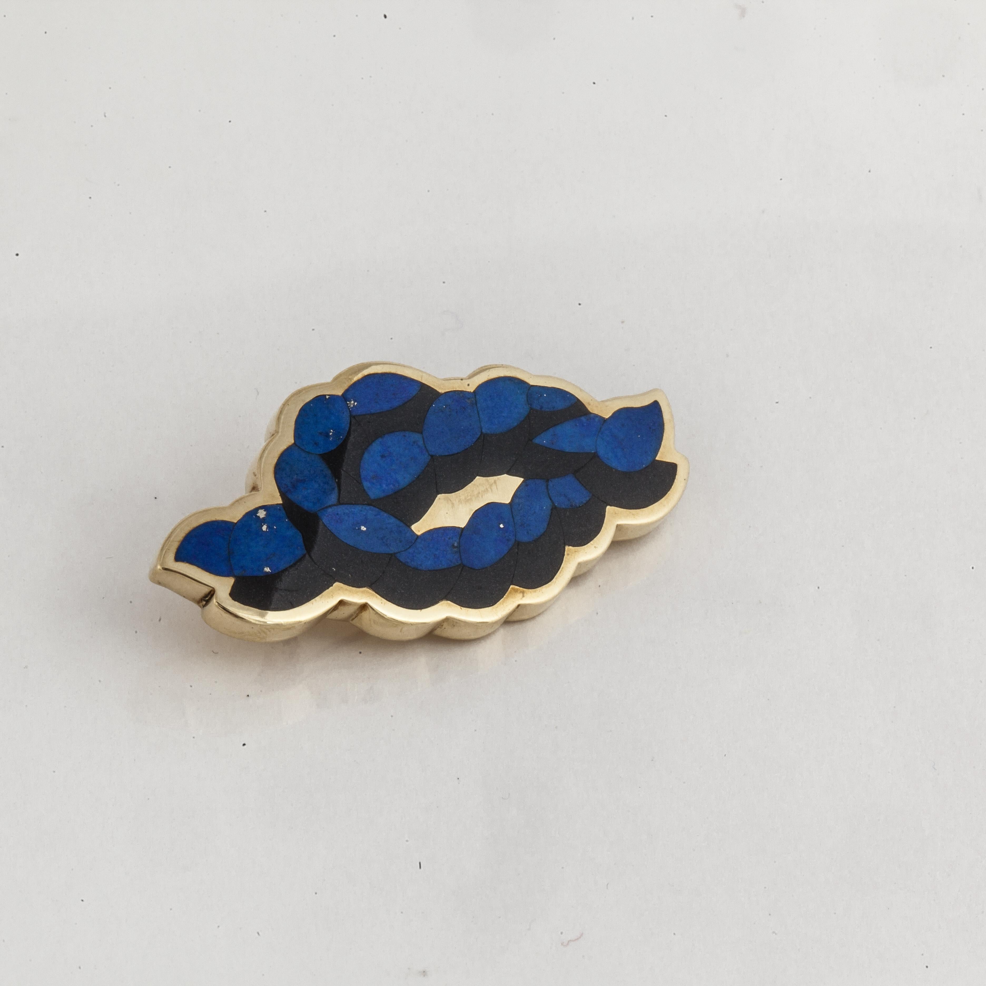 18K yellow gold pin by Angela Cummings for Tiffany & Co.  It is a knotted rope design with inlaid onyx and lapis.  Measures 1-7/8