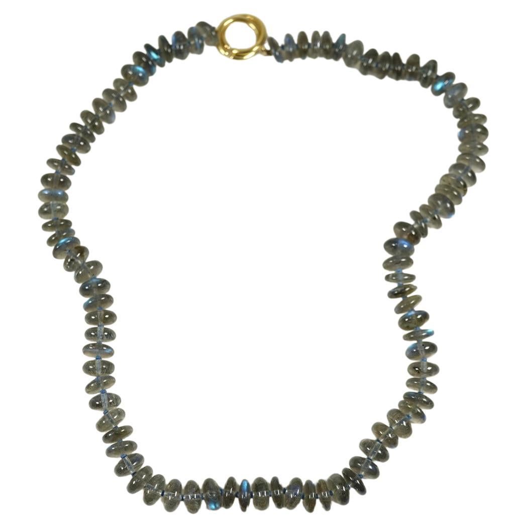 By famed jewelry house Tiffany & Co. this beautiful strand of individually knotted, labradorite beads is secured with an 18 karat yellow gold clasp. 
With original Tiffany pouch. 