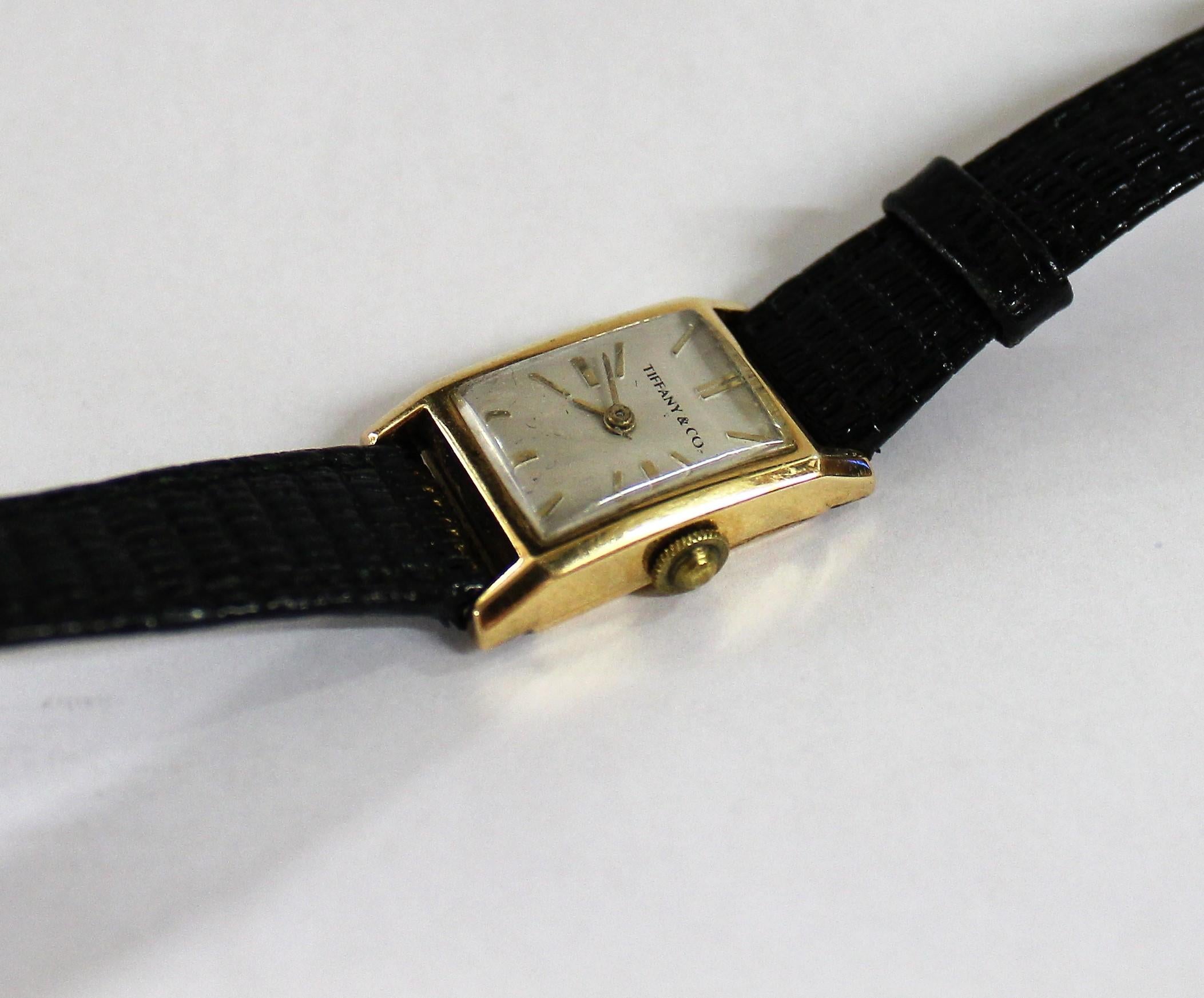 Elegant vintage Tiffany & Co. manual wind dress watch made with 18-karat yellow gold. It is slender and has a soft rectangular design.