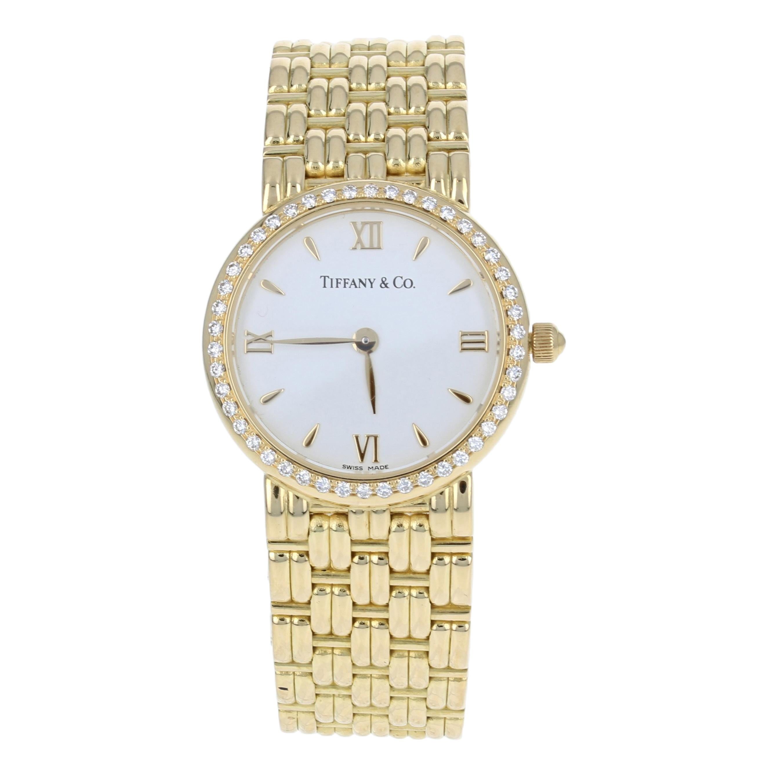 This is an authentic Tiffany & Co. wristwatch. The watch has been professionally serviced and comes with a two-year warranty.

Brand: Tiffany & Co. 
Material: 18k Yellow Gold

Stone Information:
Natural Diamonds  
Clarity: VS1 
Color: F  
Cut: Round