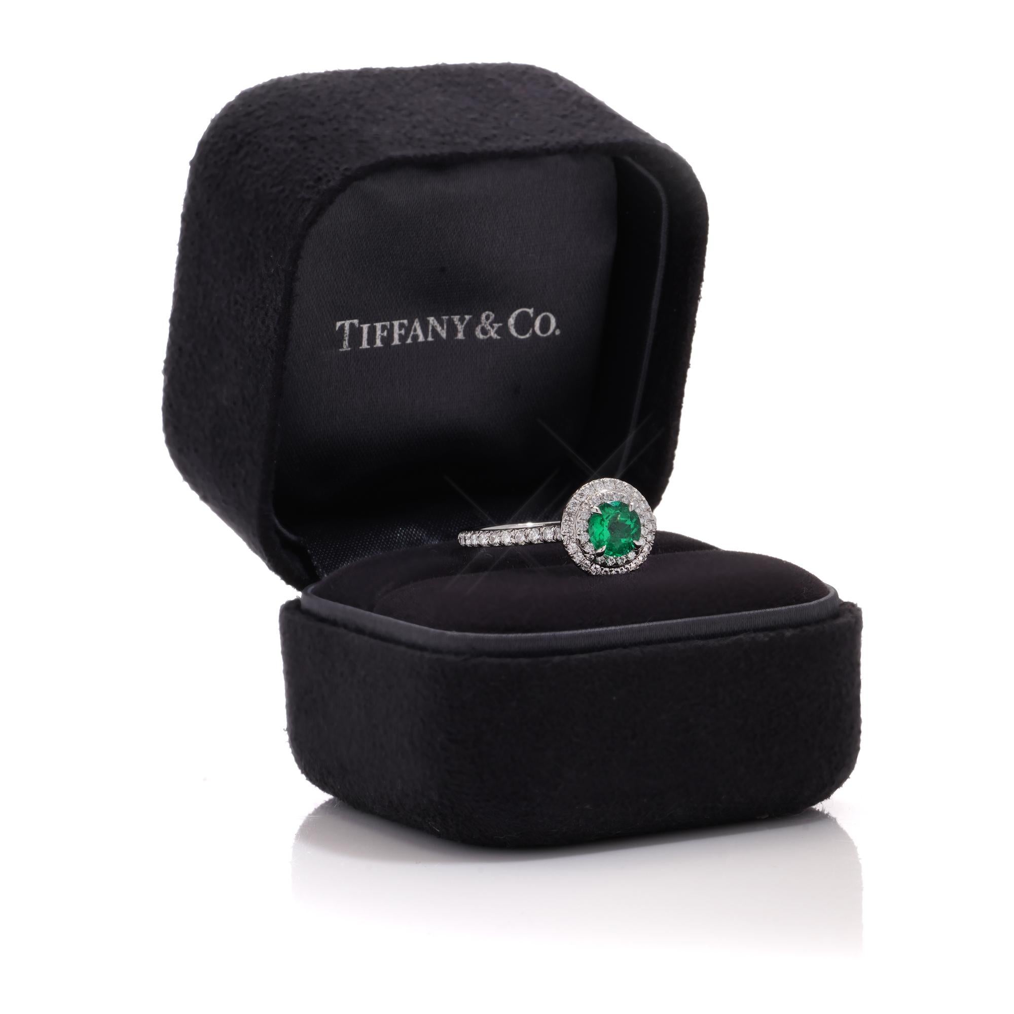 Tiffany & Co ladies platinum emerald and diamond ring.
Maker: Tiffany & Co.
Fully hallmarked.

Approx. Dimensions -
Size: 2.7 x 2 x 1 cm
Finger Size (UK) = N (US) = 7 (EU) = 54
Weight: 4.28 grams

Emerald - 
Size: 0.60 cts
Cut: Round brilliant
