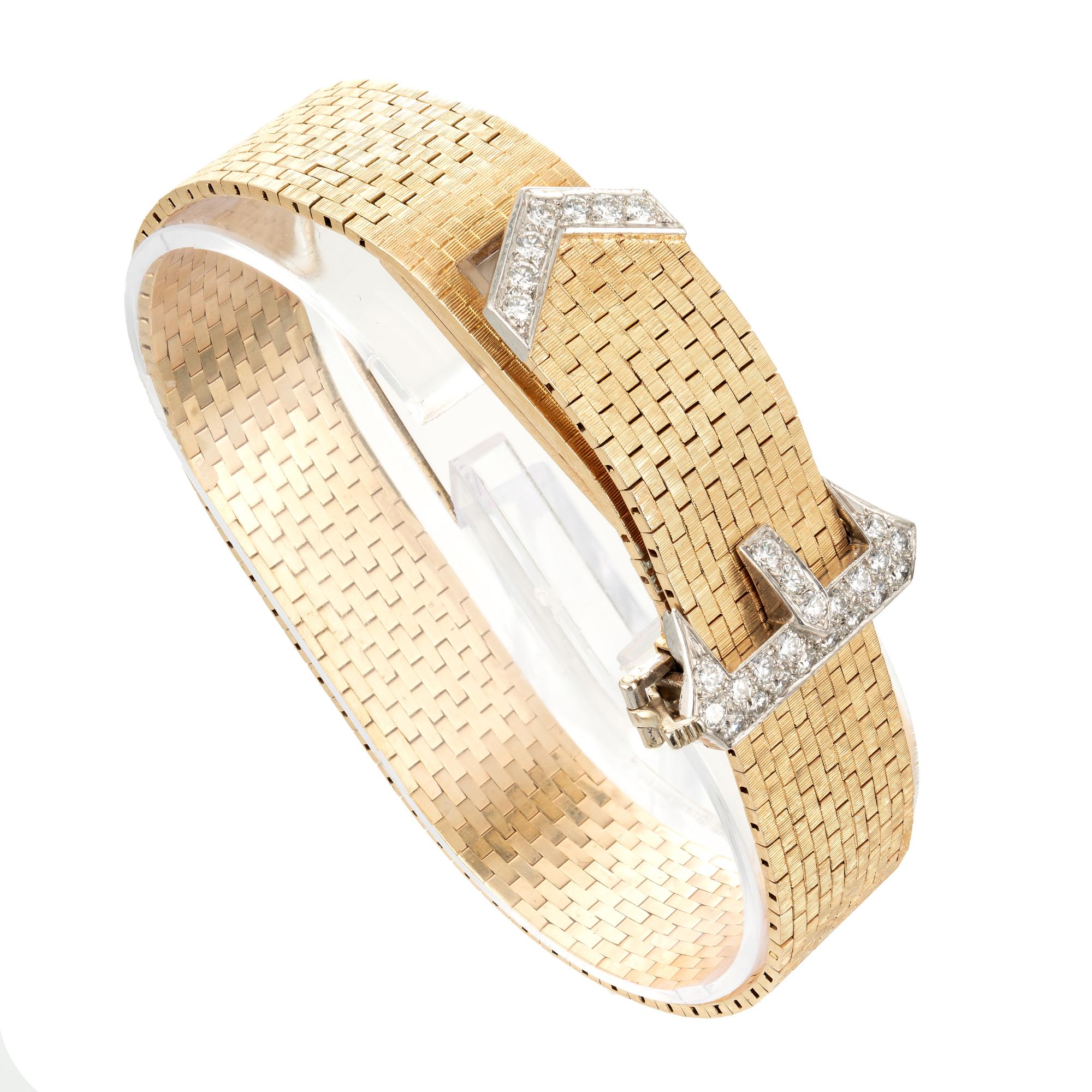 Tiffany & Co lady's 14k yellow gold and diamond buckle bracelet wristwatch, cira 1950s. 28 round full-cut diamonds.  17-jewel manual-wind Concord movement.

28 round diamonds approx. total weight .80cts total, F, VS
14k yellow gold
Length: