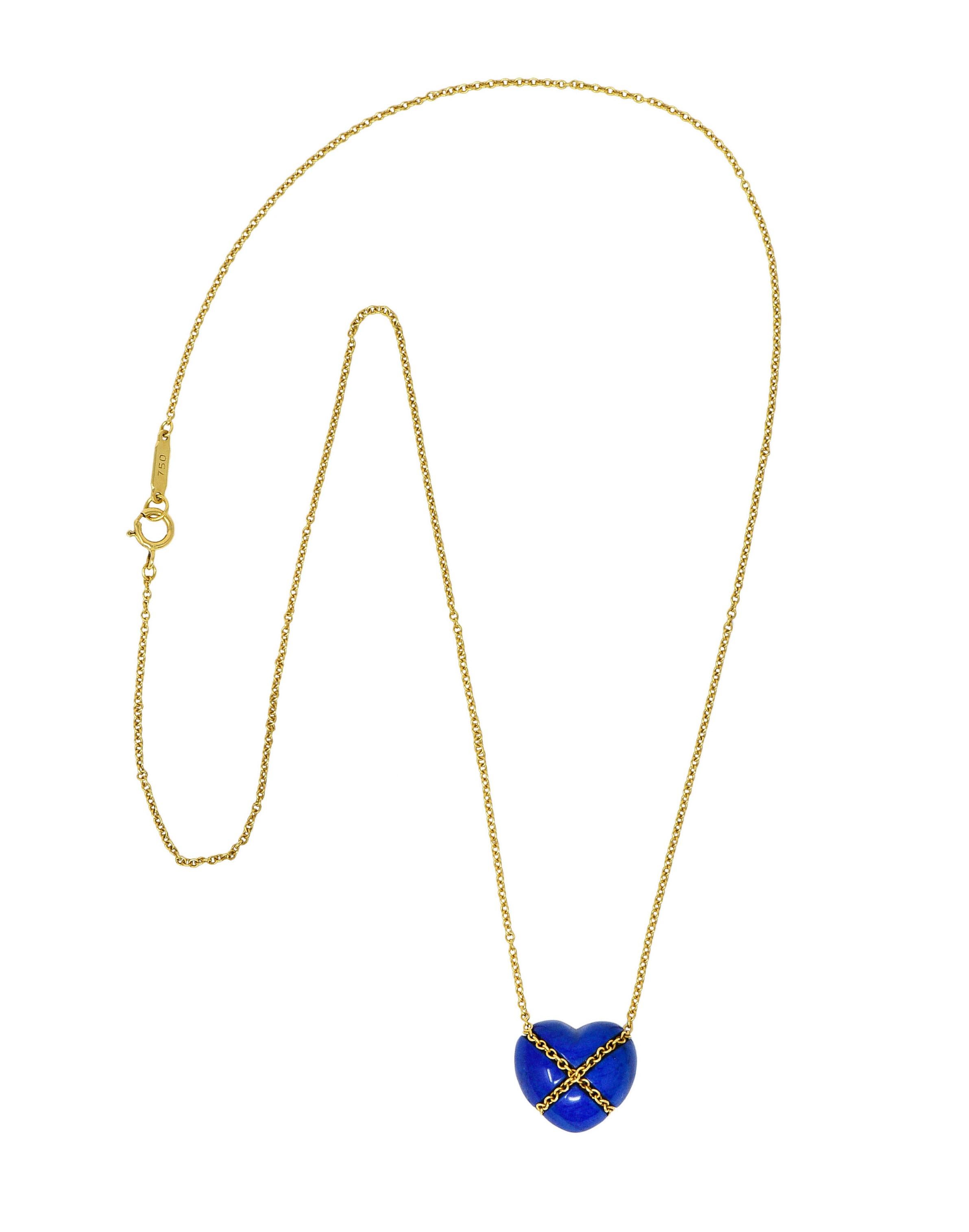 Classic cable chain necklace centers a lapis lazuli heart cabochon

Opaque and is uniformly ultramarine blue in color

Tightly wrapped with cable chain in an X motif

Necklace completes as a spring ring clasp

Logo link is stamped 750 for 18 karat