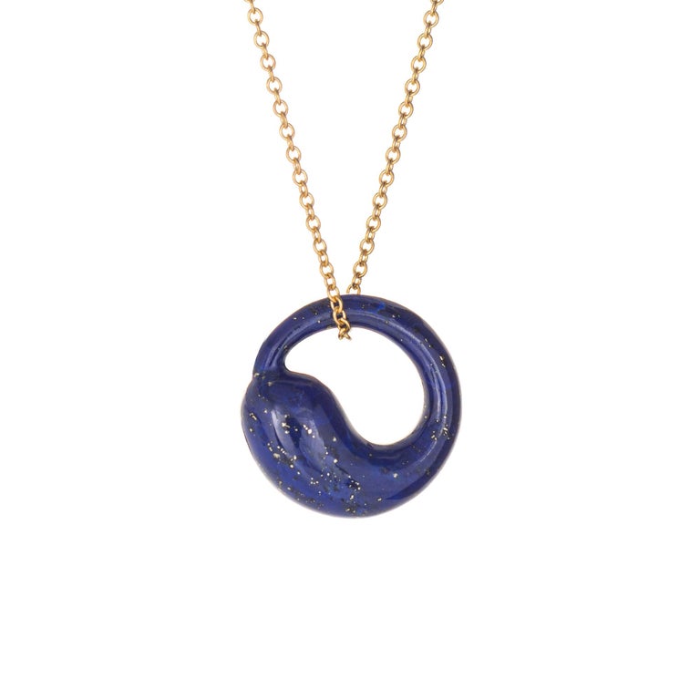 Elegant and finely detailed estate Tiffany & Co lapis lazuli 'Eternal Circle' necklace crafted in 18 karat yellow gold.  

Lapis lazuli measures 15mm diameter (0.59 inches). The lapis is in excellent condition and free of cracks or chips.  

The
