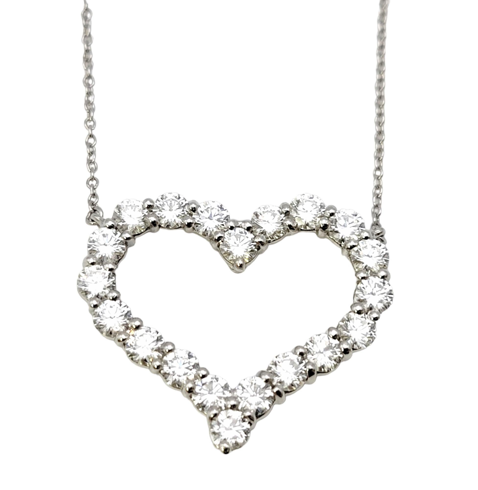 You will fall head over heels in love with this breathtaking diamond open heart pendant necklace from renowned jeweler, Tiffany & Co. This incredible necklace truly sparkles from every angle and looks absolutely radiant on the neck! 

This gorgeous