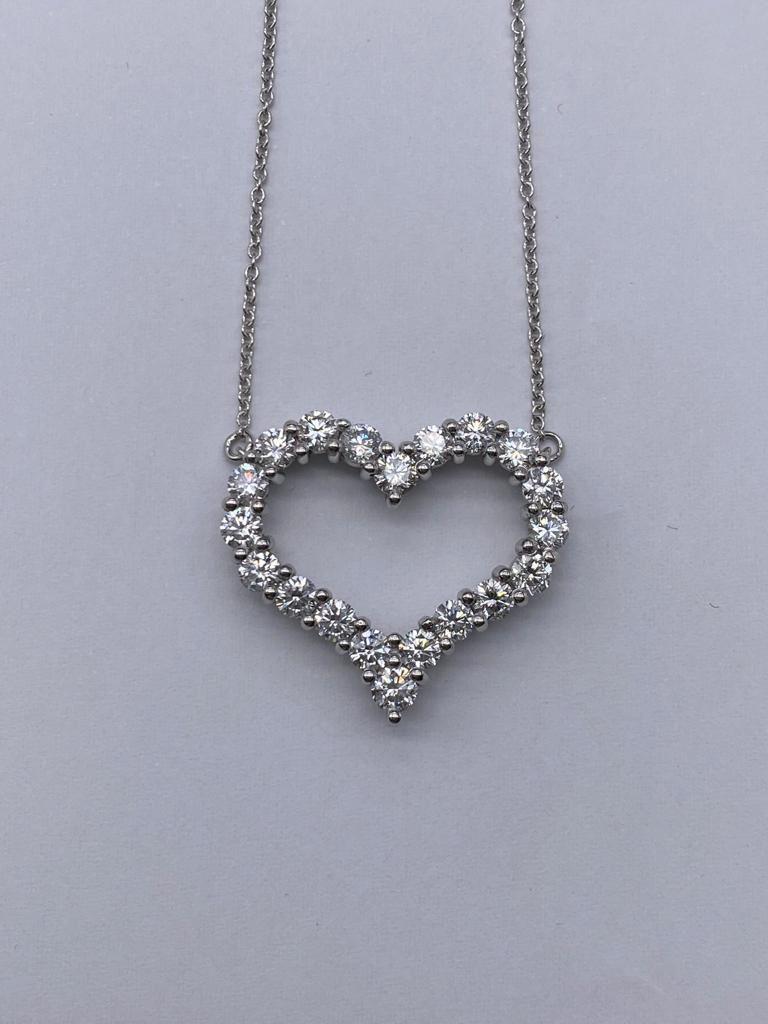 Tiffany Co Large Diamond Heart This gorgeous necklace features 20 round brilliant diamonds prong set in a lovely open heart design. The diamonds are a dazzling E-G in color and VS clarity range, and are set in polished platinum to showcase their