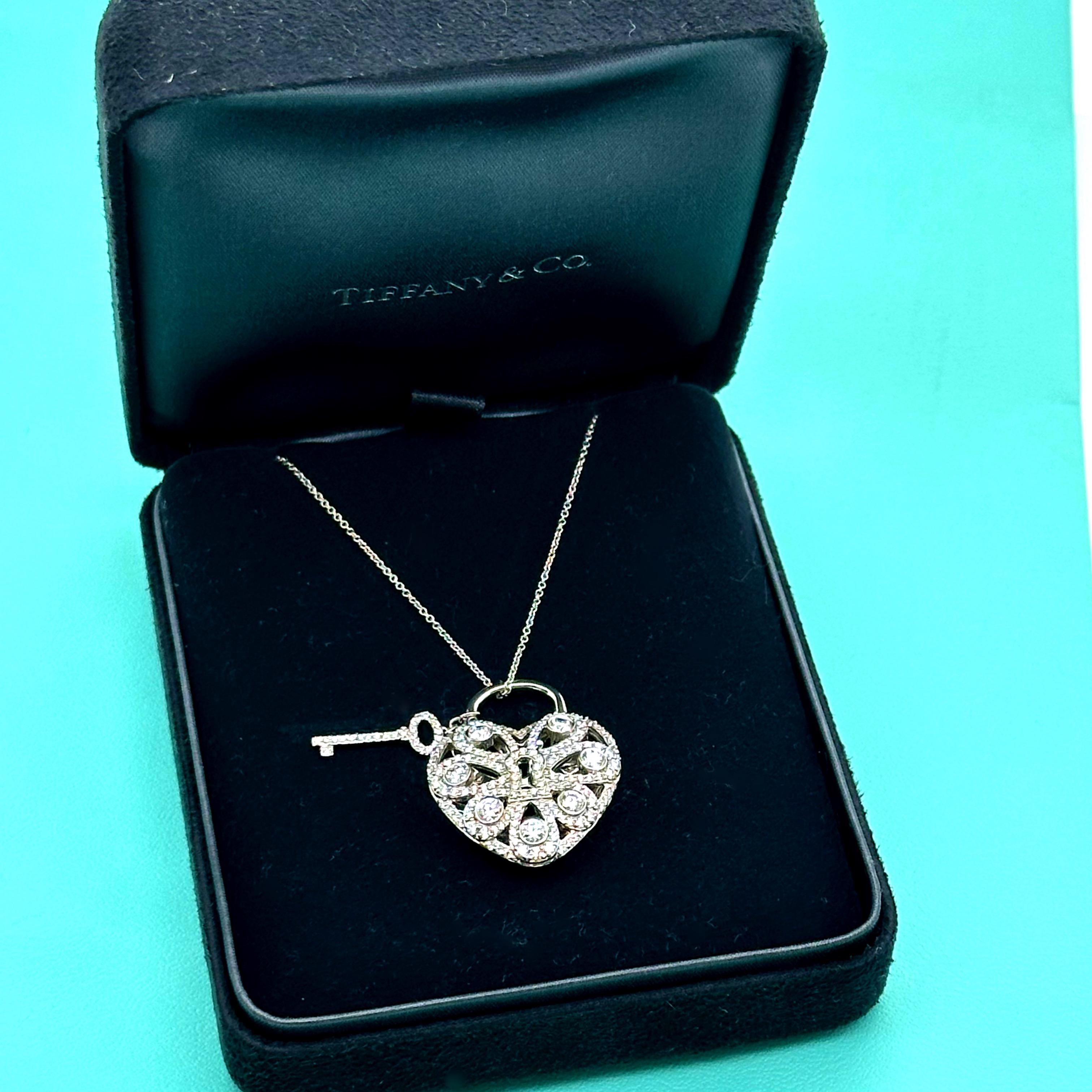 Tiffany & Co. Filigree Heart Key Pendant Necklace
Style:  Pendnat
Metal:   18kt White Gold
Size / Measurements:  18' Inches / Pendant 1 x 1 Inches
TCW:  1.44 tcw
Main Diamond:  ~ 176 Round Brilliant Diamonds
Comments:  Intricate Filigree design on