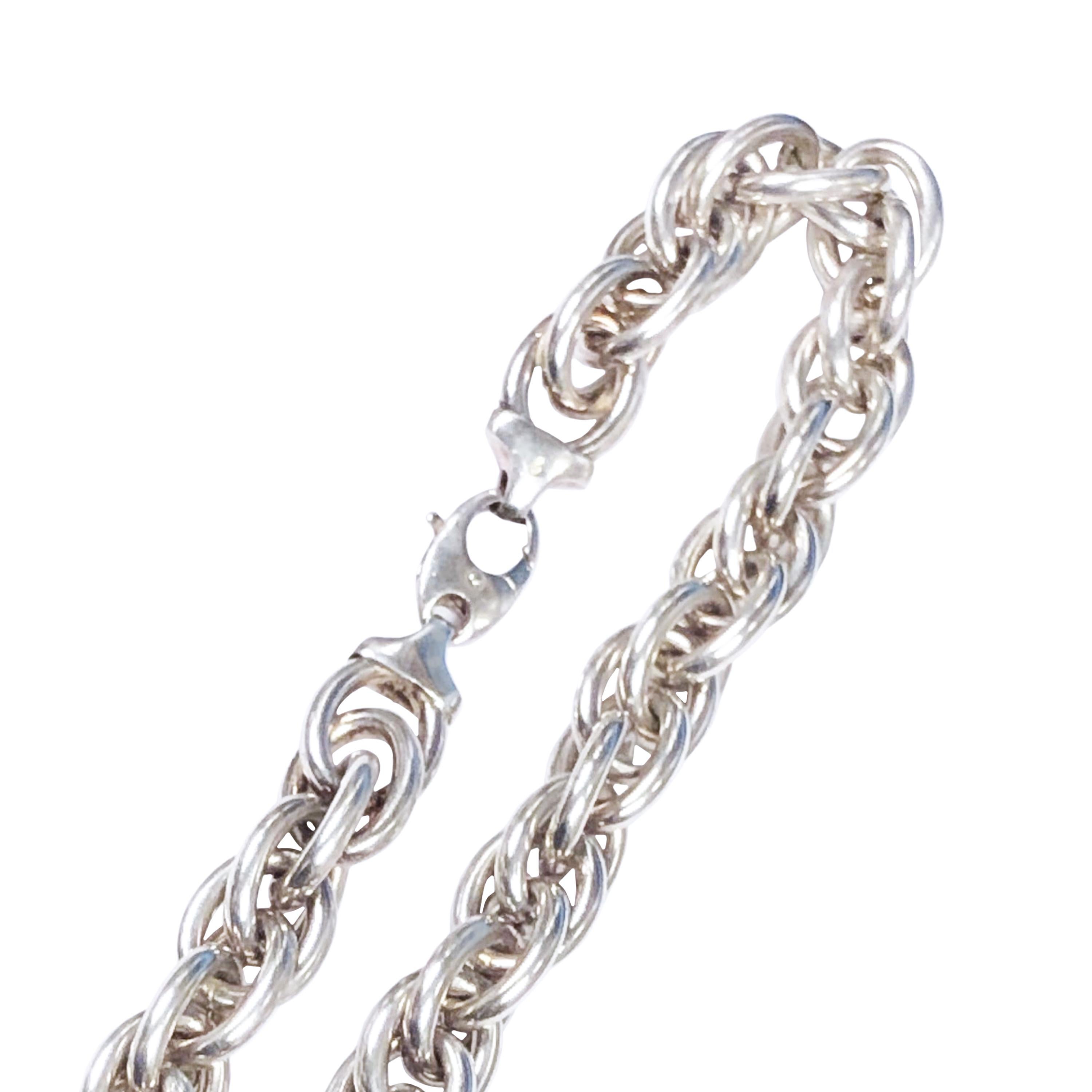 Circa 1980s Tiffany and Company Sterling Silver Necklace, comprised of interwoven links, measuring 17 inches in length and 5/8 inch wide. weighing 3 1/2 ounces. 