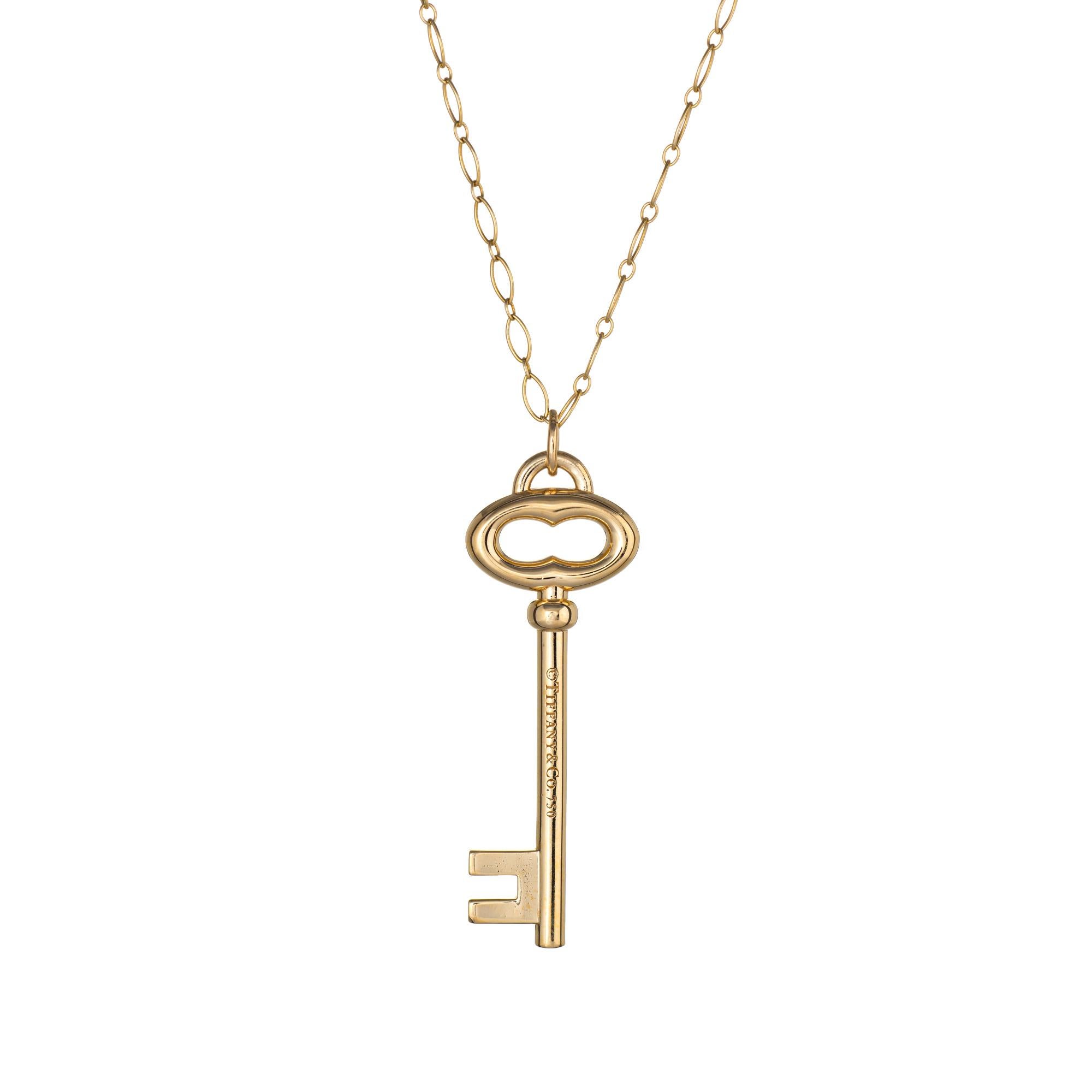 Elegant and finely detailed estate Tiffany & Co large key pendant & necklace crafted in 18 karat yellow gold.  

The large key measures 2 inches in length and comes with a 20 1/2 inch Tiffany & Co chain.  

The necklace is a retired piece and no