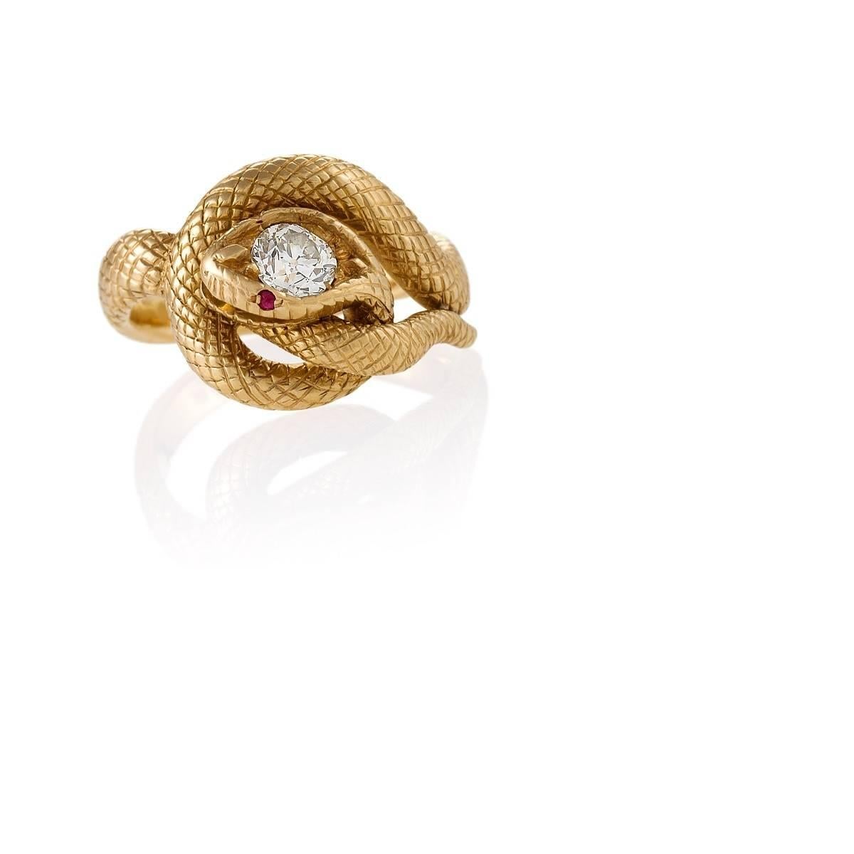 An American Late-19th Century 18 karat gold serpent ring with diamond and rubies by Tiffany & Co. The ring has an old European-cut diamond with an approximate weight of .60 carat, and 2 round ruby eyes with an approximate total weight of .04  carat.