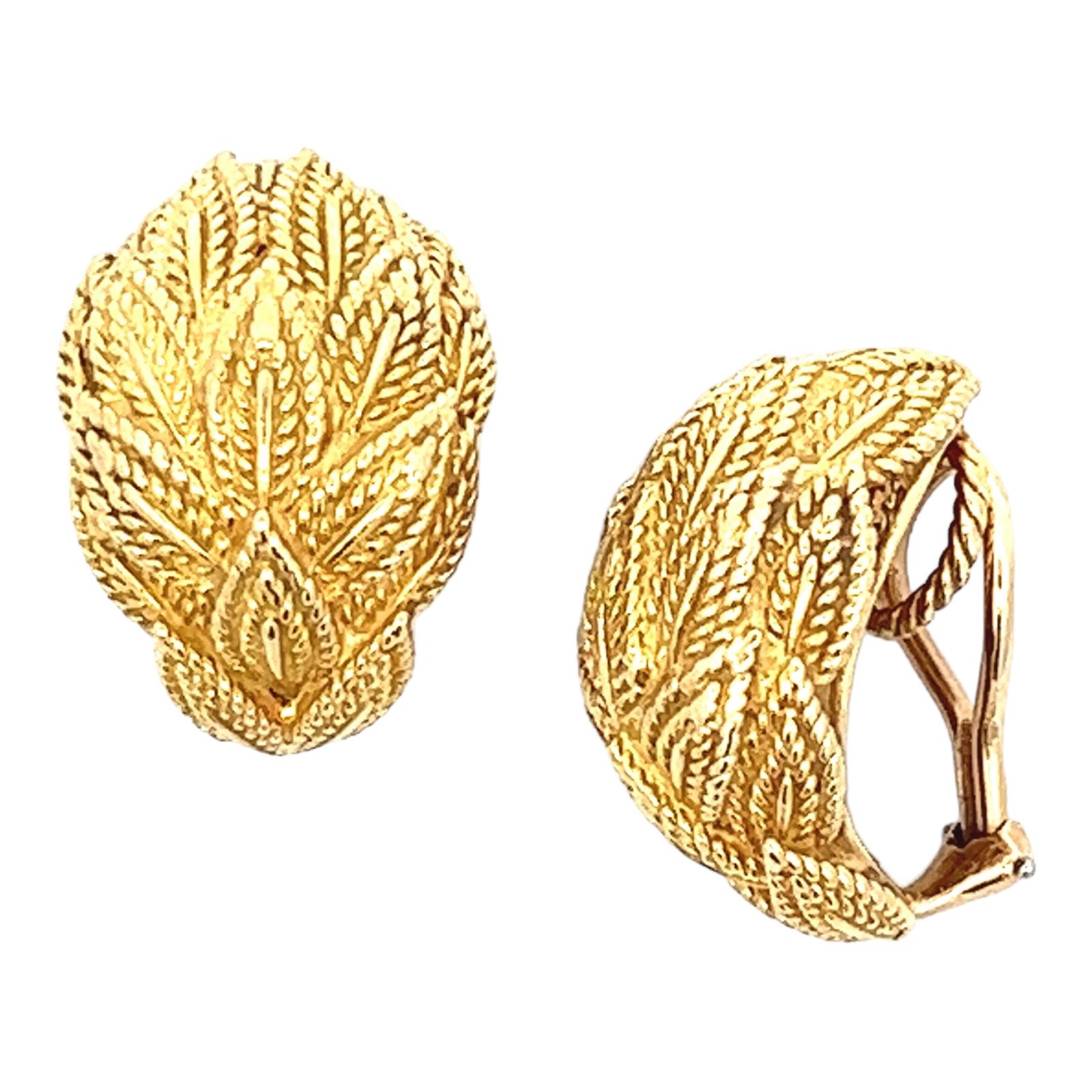 Tiffany & Co. Leaf earrings crafted in 18 karat yellow gold. The earrings feature a textured leaf motif, measure 12 x 22mm, and clip-on leverbacks (posts can be added). Signed Tiffany & Co. 18k. 