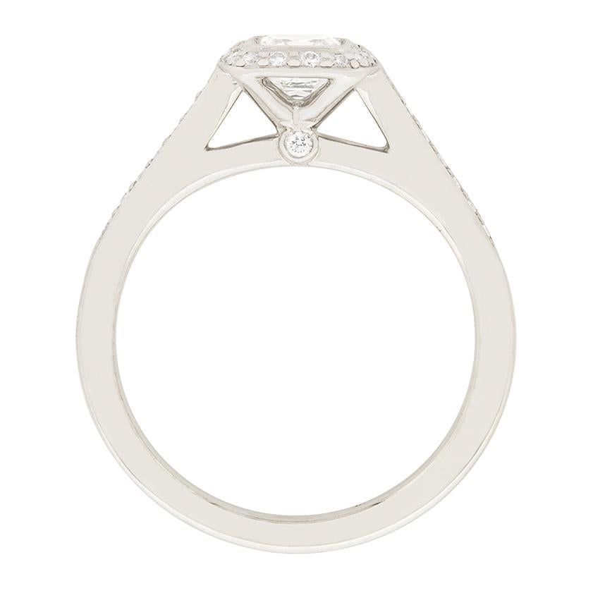 This Tiffany & Co. 'Legacy' engagement ring features a 0.41 carat modified asscher cut diamond. It is an H colour and VS1 clarity. Surrounding the centre diamond is a halo of round brilliant cut diamonds, totalling to 0.30 carat. This ring has all