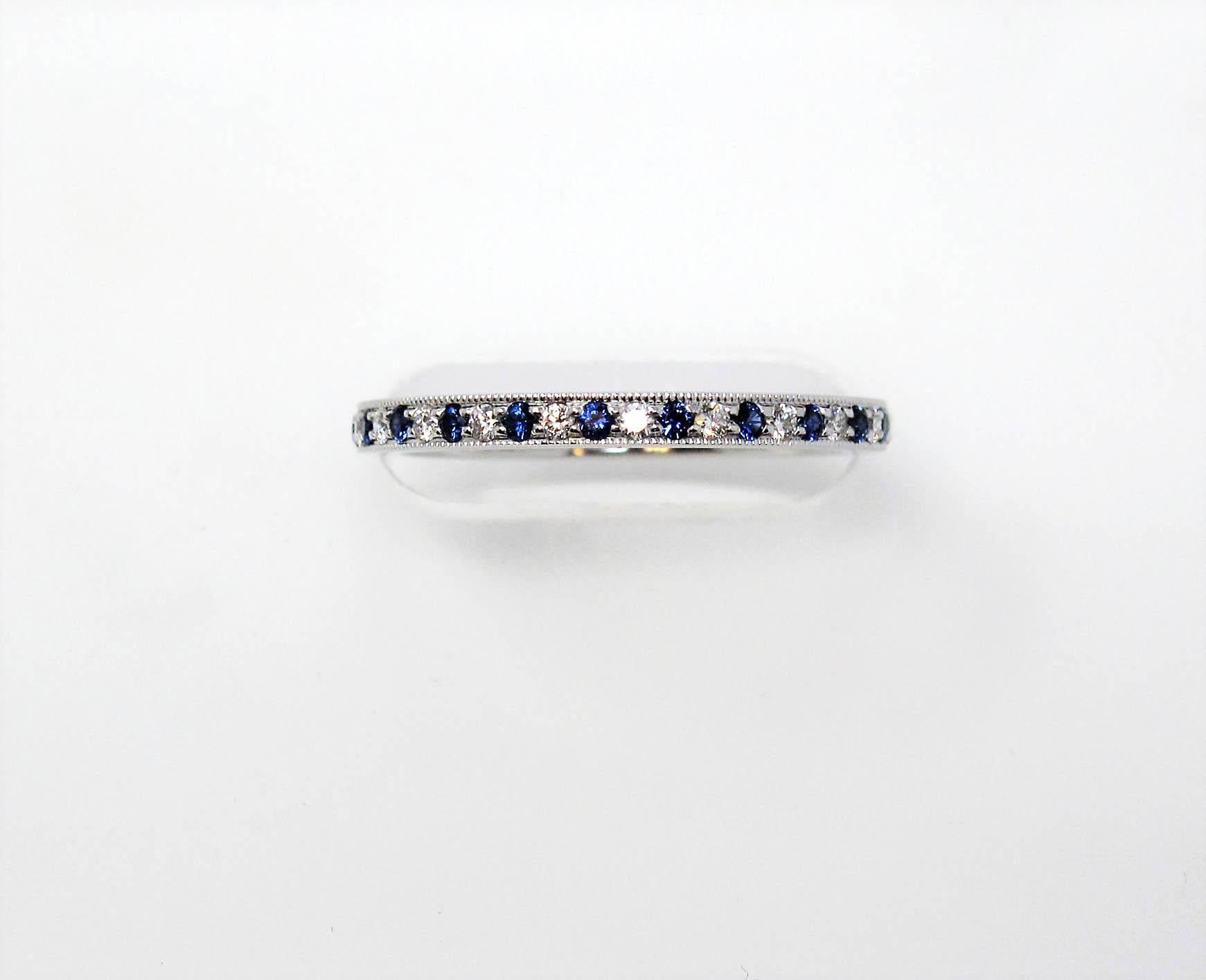 Stunning Tiffany & Co. Legacy Collection sapphire and diamond eternity band ring. This timeless beauty features bright blue sapphires and icy white diamonds bead set in an alternating pattern throughout the piece. The thin, milgrain edged band is