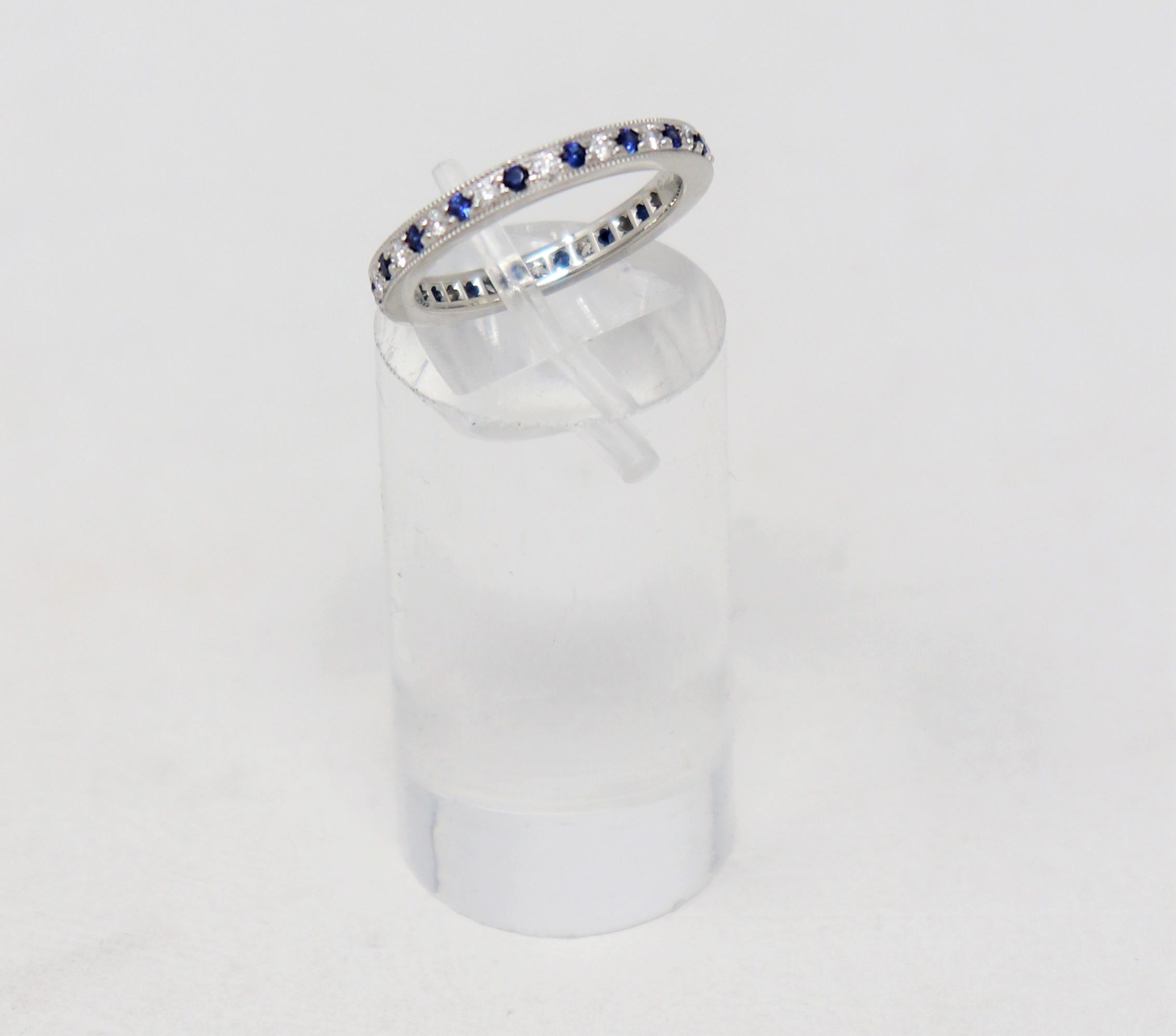 Ring size: 4.25

Stunning Tiffany & Co. Legacy Collection sapphire and diamond eternity band ring. This timeless beauty features bright blue sapphires and icy white diamonds bead set in an alternating pattern throughout the piece. The thin, milgrain