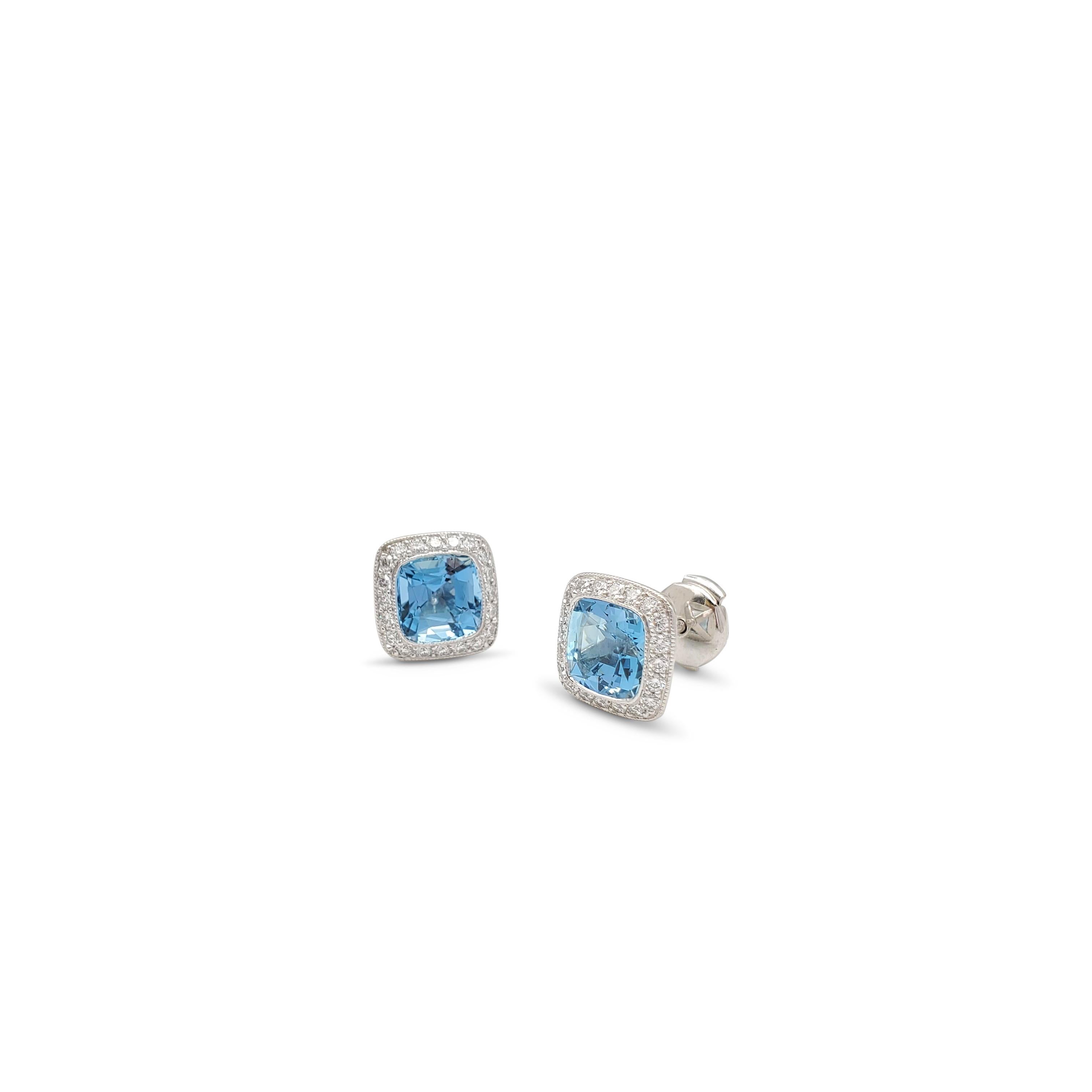 Authentic Tiffany & Co. 'Legacy' earrings crafted in platinum, center on cushion cut aquamarine stones weighing an estimated 4.00 carats. The vibrant aquamarine stones are surrounded by high-quality round brilliant cut diamonds (E-F color, VS
