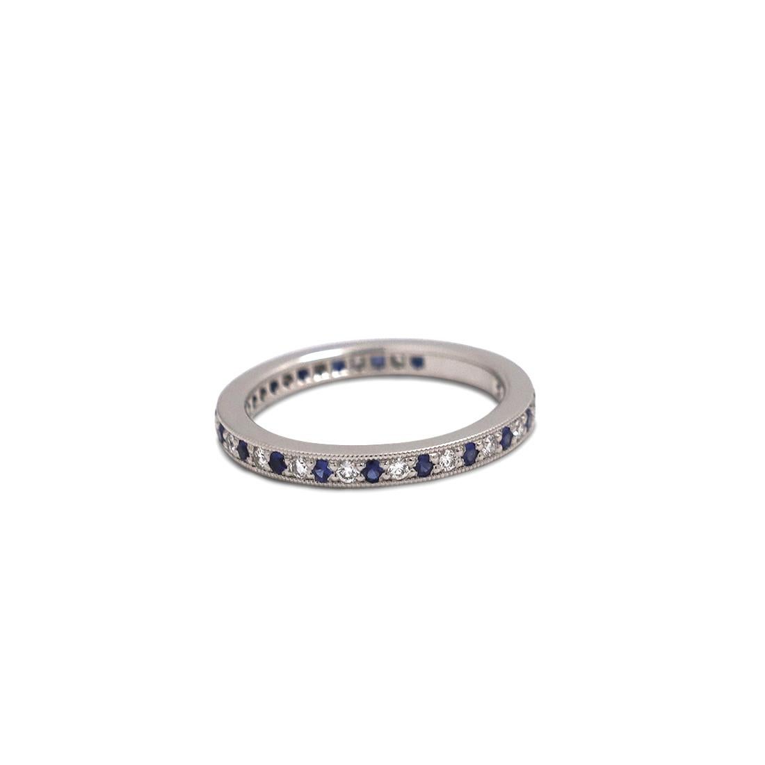Authentic Tiffany & Co. 'Legacy' band ring evokes the glamour of the Edwardian period. The ring is crafted in platinum with a milgrain edge and a full circle of bead-set high-quality round brilliant cut diamonds weighing an estimated 0.20 carats