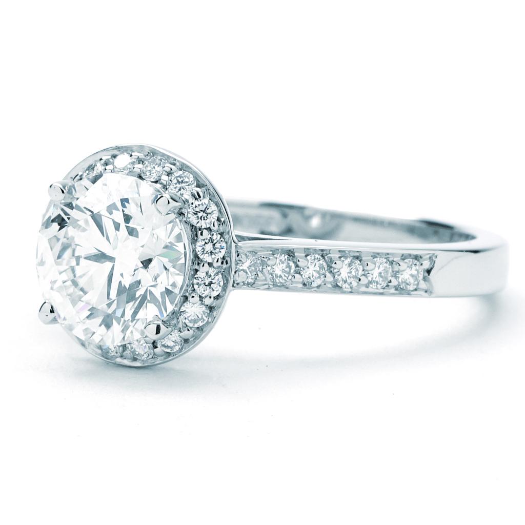 This Tiffany & Co. Legacy ring is made of platinum and weighs 3.00 DWT (approx. 4.67 grams). It contains one round G color and VVS2 clarity diamond weighing 1.36 CT, and 28 round G color and VS clarity diamonds weighing 0.35 CTTW.