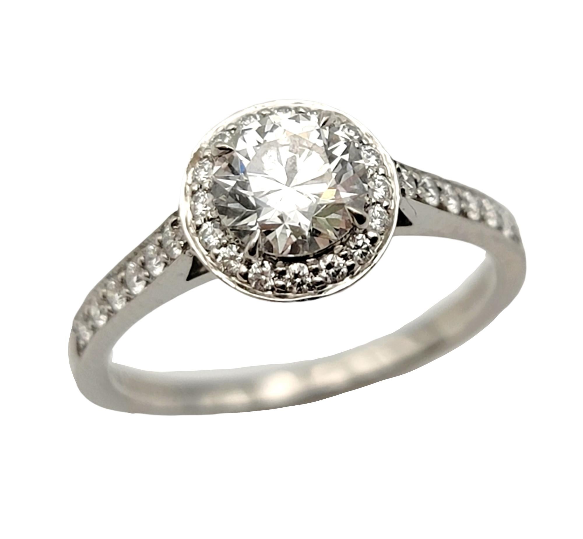Ring size: 6

Breathtaking diamond halo engagement ring from renowned jeweler, Tiffany & Co.. The luxurious Legacy ring will absolutely radiate on her finger. The striking round cut center stone is paired with a glittering halo of brilliant
