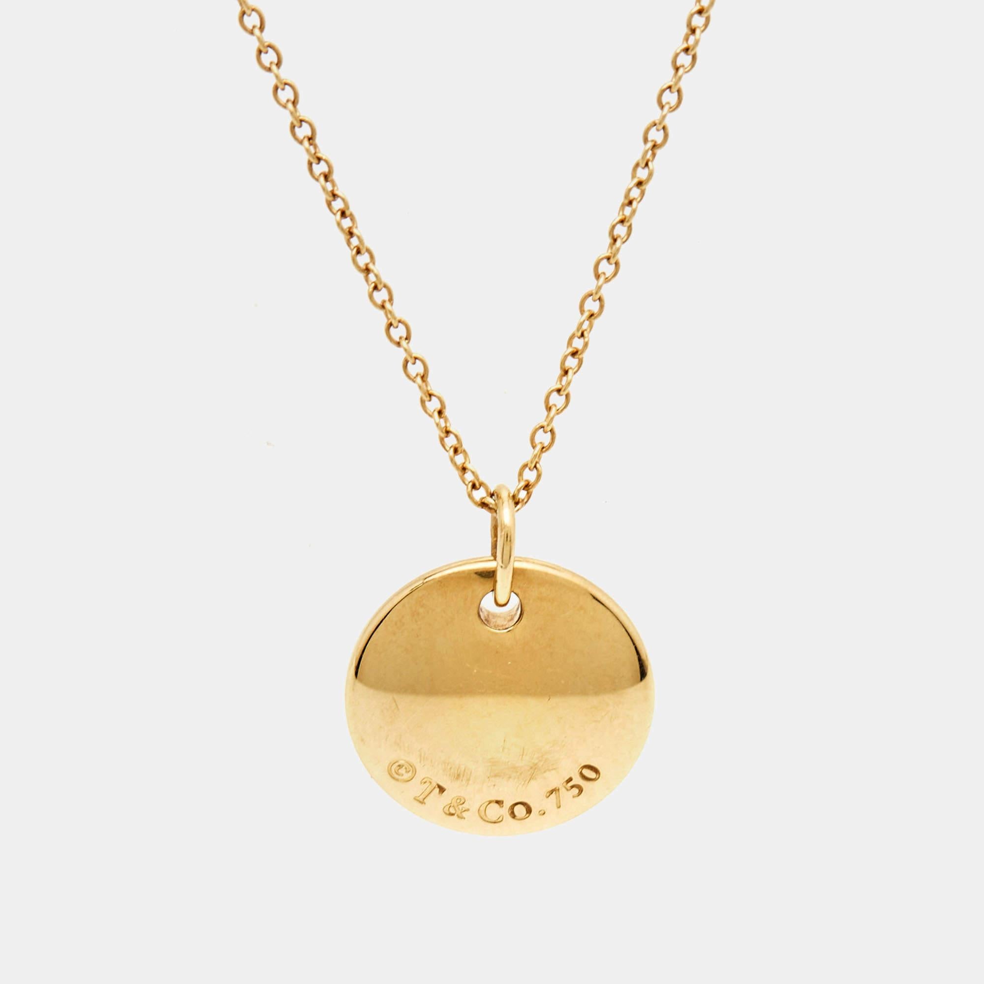 Elevate your style with the timeless elegance of the Tiffany & Co. Letter necklace. Crafted from lustrous 18k yellow gold, this exquisite piece features a delicate round pendant adorned with the letter 