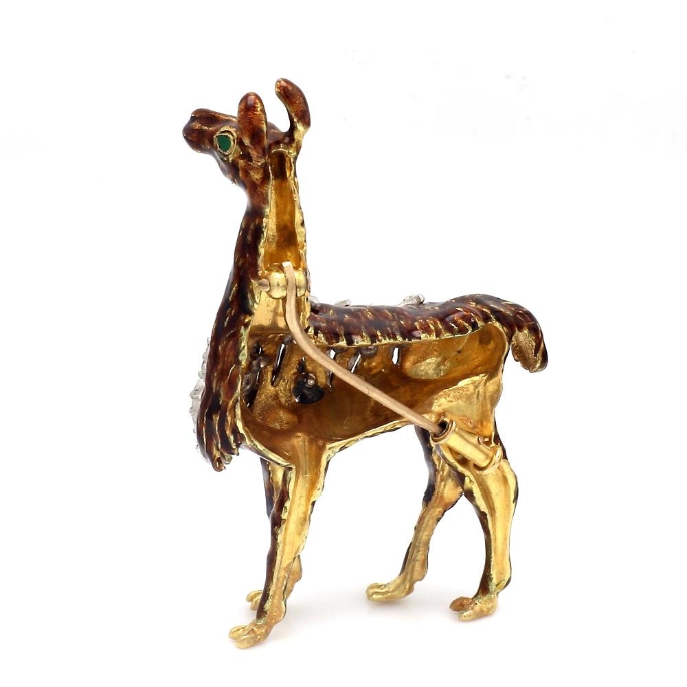 Tiffany & Co., 18K yellow gold and brown enamel, llama brooch. Brooch is set with thirty-three (33) single cut diamonds and two (2) pear shaped emeralds (eyes). Pin, hinge, and trombone clasp are in working condition. Brooch weighs 20.8 grams and