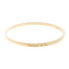 Tiffany & Co. 18 Karat Gelbgold schmales Logo-Armreif