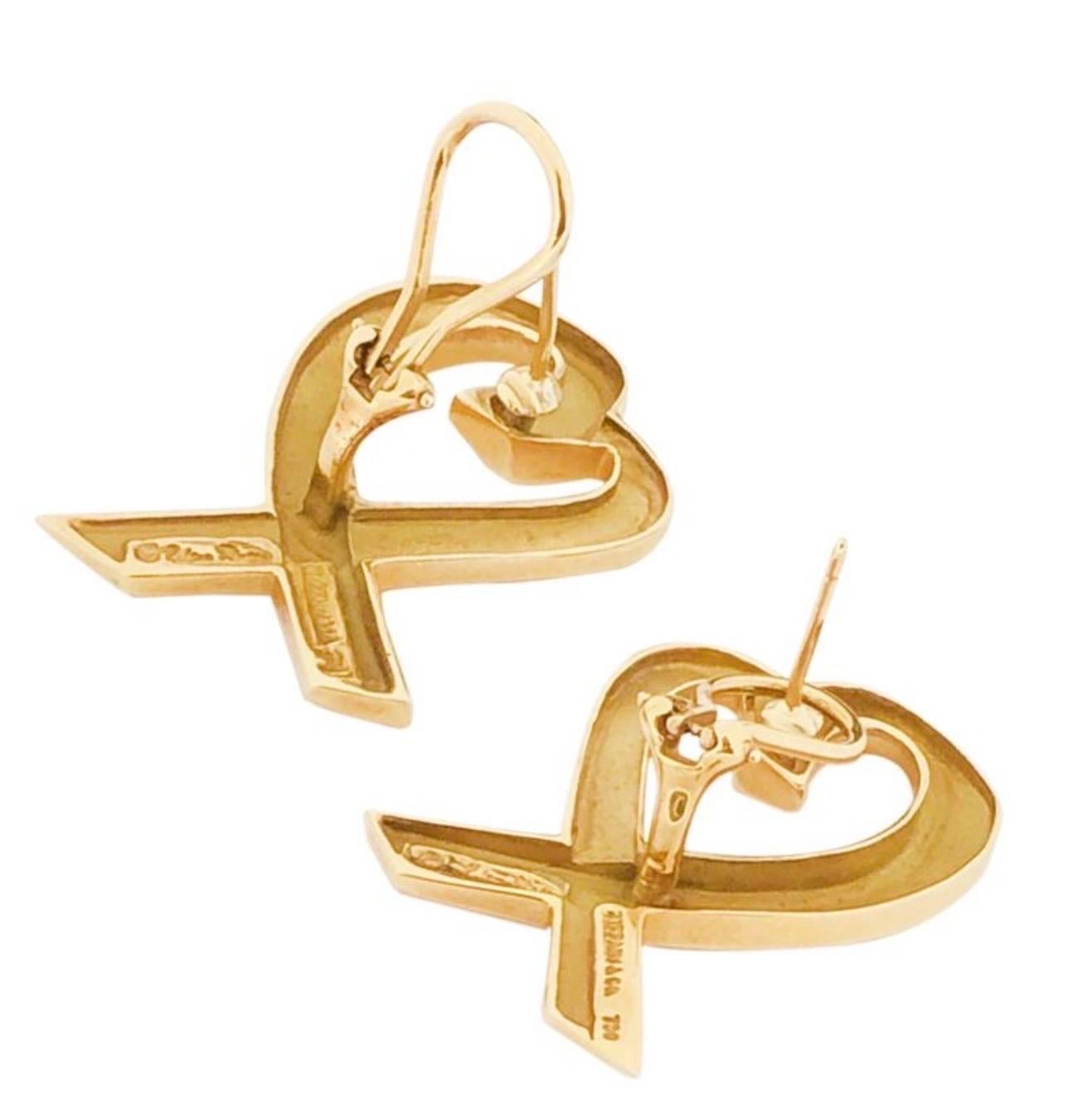 A true classic authentic pair of earrings by Tiffany & Co.
Tiffany & Co. Paloma Picasso large Yellow Gold Loving Heart Earrings
These authentic Tiffany & Co earrings are finely crafted from solid 18k Yellow gold. 

Material: Solid 18k Yellow gold 22