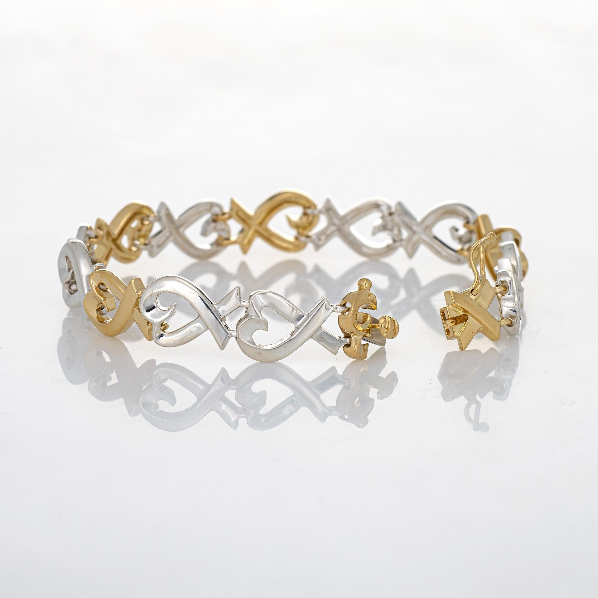 Stylish and finely detailed estate Tiffany & Co Loving Hearts bracelet crafted in 18k yellow gold & sterling silver.  

The bracelet features an alternating pattern of whimsical open hearts in sterling silver & 18k yellow gold. The bracelet is
