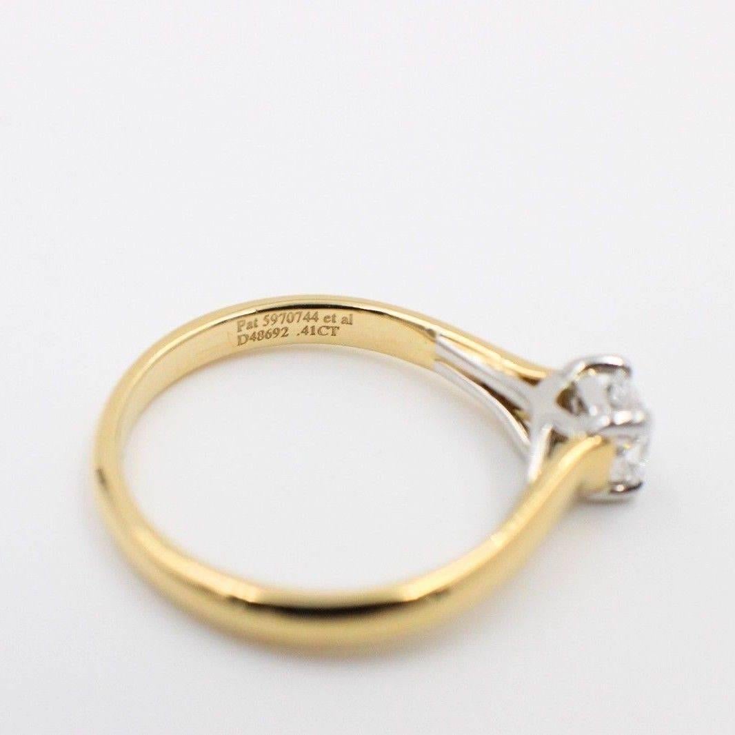 Tiffany & Co.
Style:  Lucida Solitaire
Serial Number:  D48692
Metal:   18Kt Yellow Gold & Platinum PT950
Size: 5.75 - sizable  
Total Carat Weight:  0.41 Cts
Diamond Shape:  Lucida
Diamond Color & Clarity:  D / VVS1
Hallmark:   1999 TIFFANY&CO.