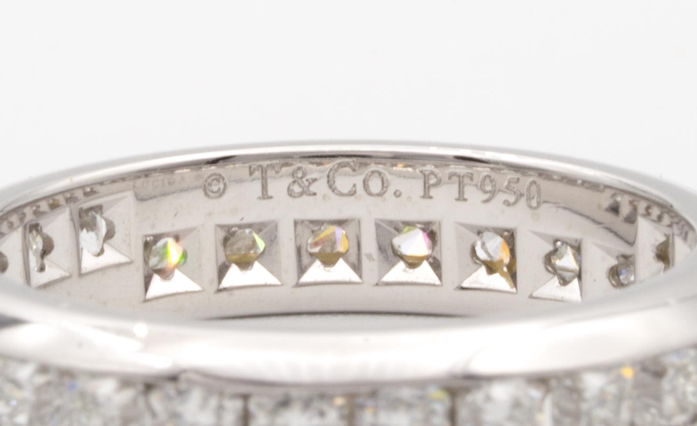A classic Tiffany & Co. Lucida diamond eternity ring finely crafted in platinum with 28 Lucida cut channel set diamonds all the way around weighing approximately 1.37 carats. Fine quality diamonds F color, VVS2-VS1 clarity. The band measures 4.15 mm