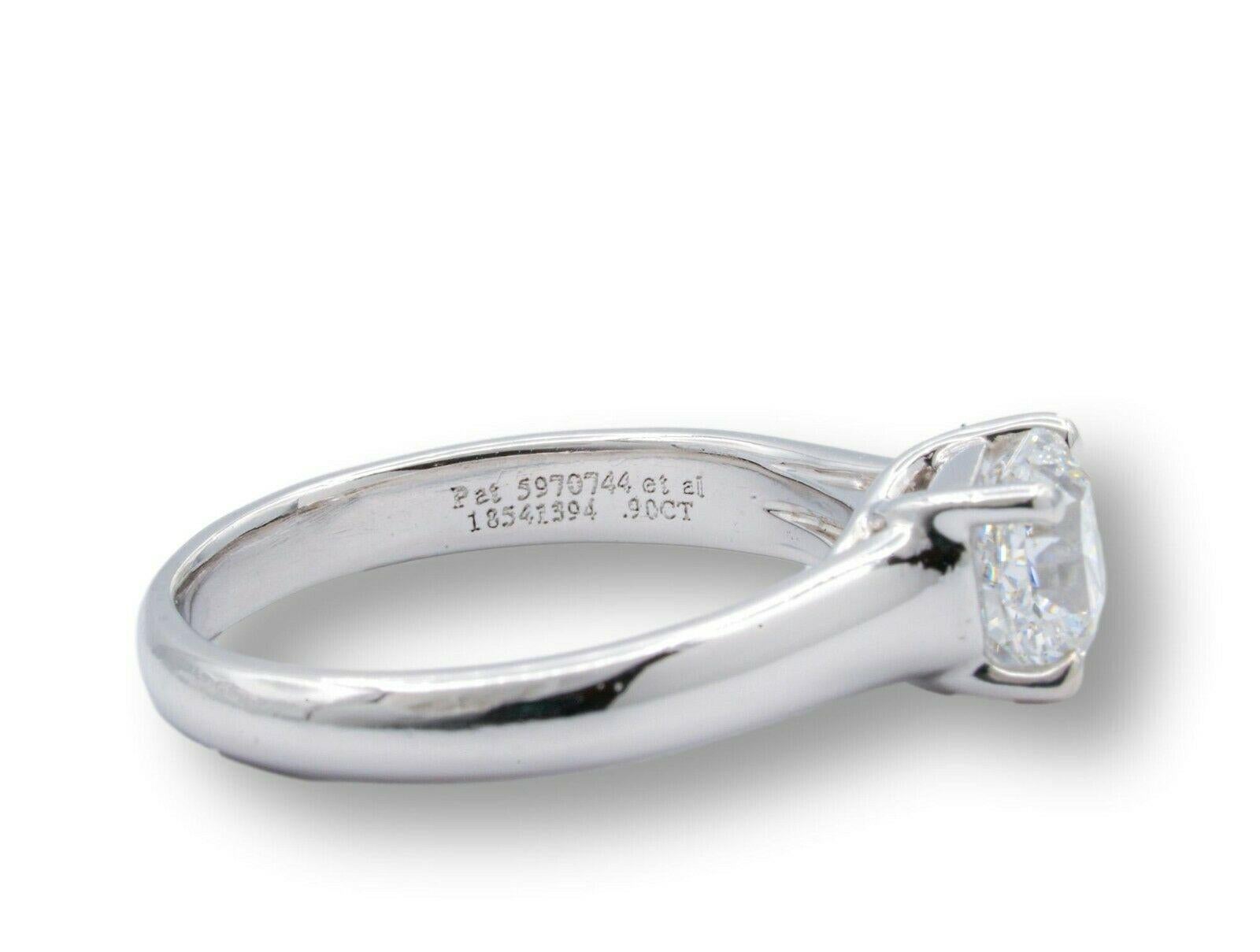 Tiffany & Co Lucida engagement ring with 0.90 carat center E color VS1 clarity finely crafted in Platinum.  
Includes certificate from Tiffany. Excellent cut.
This ring would retail today at $13,900 based on Tiffany True cut pricing
  
  Stamp: