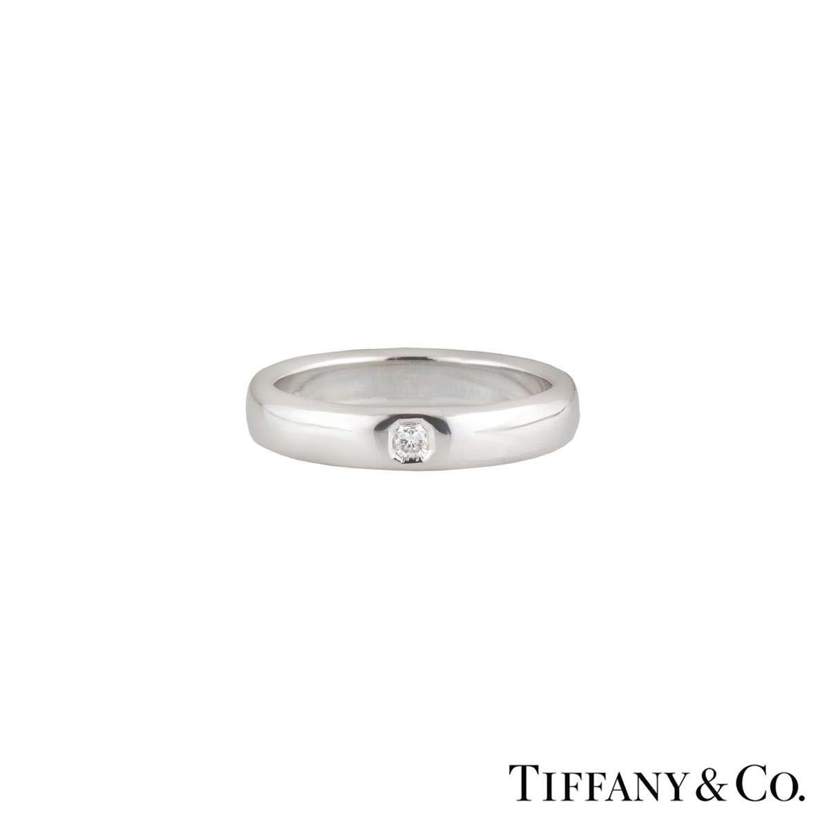 A stylish Tiffany & Co Diamond Wedding Band in Platinum from the Lucida collection. The ring features a bezel set Lucida cut diamond with a total weight of 0.05ct, G colour and VS clarity. The 4mm wide ring is a court fit band in a size UK M½/US