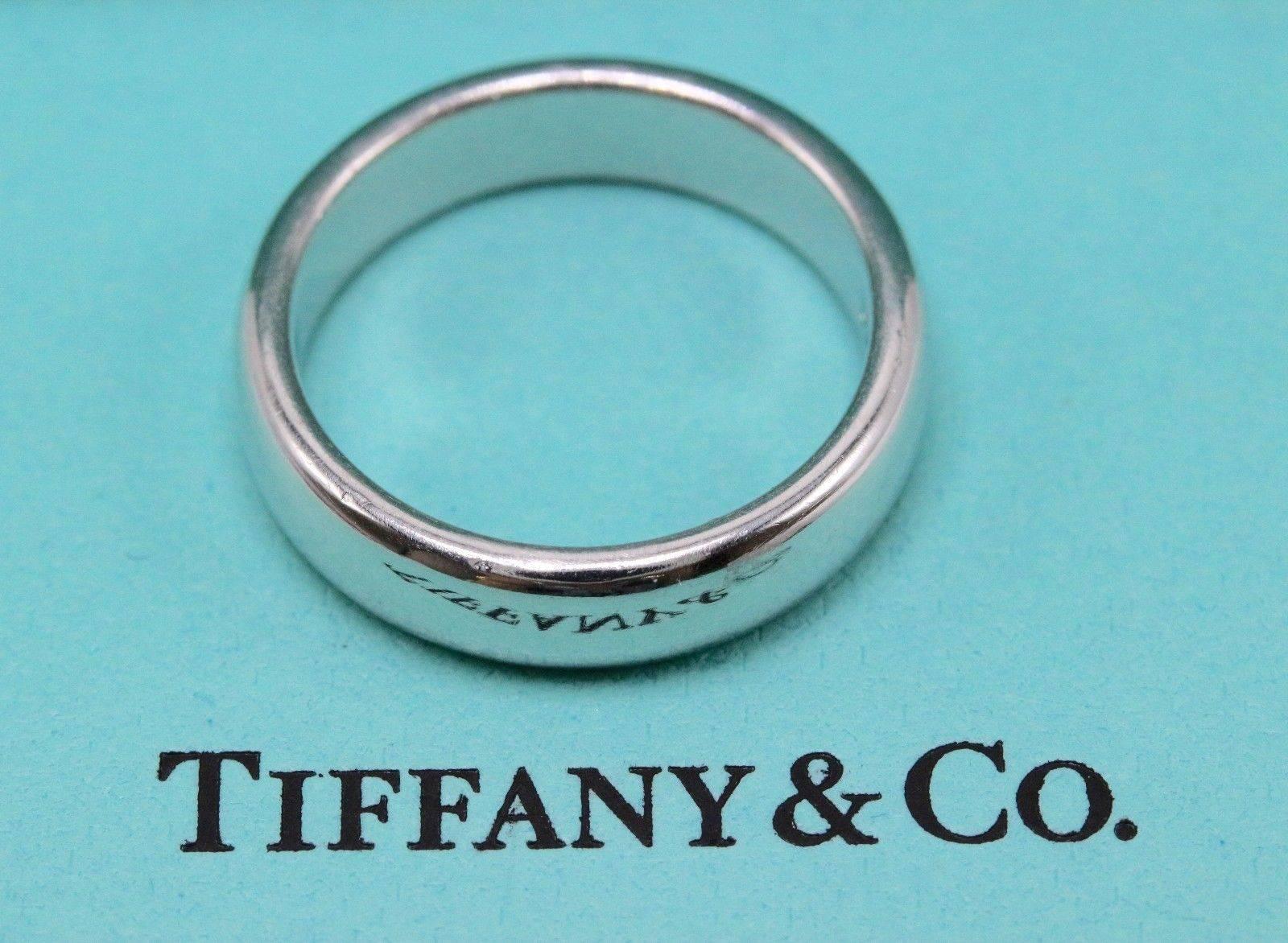 Tiffany & Co.
Style:  Lucida Wedding Band
SKU Number:  14762949
Metal:  Platinum PT950
Size:  5 - sizable  
Width:  4.5 MM  
Hallmark:  ©1999 TIFFANY&CO.PT950
Includes:  Tiffany & Co. Jewelry Pouch

Retail Value:  $1,775 + tax = $1,912.56