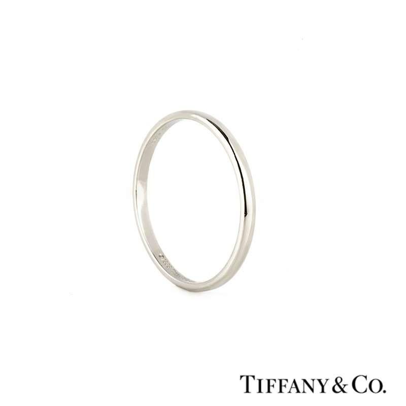 A Tiffany & Co platinum wedding band from the Lucida collection. The 2mm ring is of D-shape design and features a highly polished finish. The ring is currently a size UK V/US 10.5/EU 64 but can be adjusted for a perfect fit and has a gross weight of