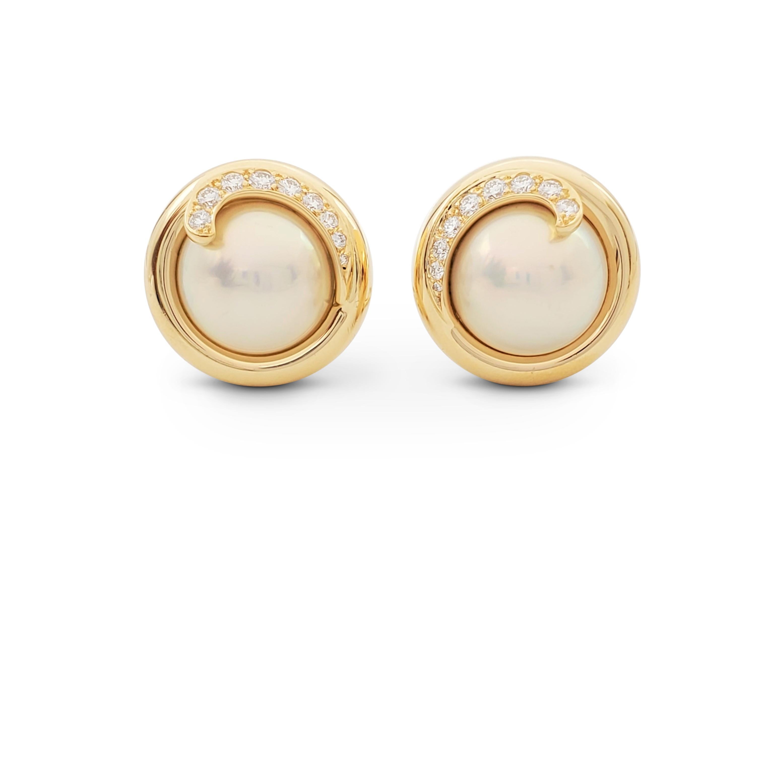 Authentic Tiffany & Co. earrings crafted in 18 karat yellow gold centering on cream-colored mabe pearls each enhanced by a smattering of sparkling round brilliant cut diamonds (E-F color, VS clarity) weighing an estimated 0.45 carats in total.