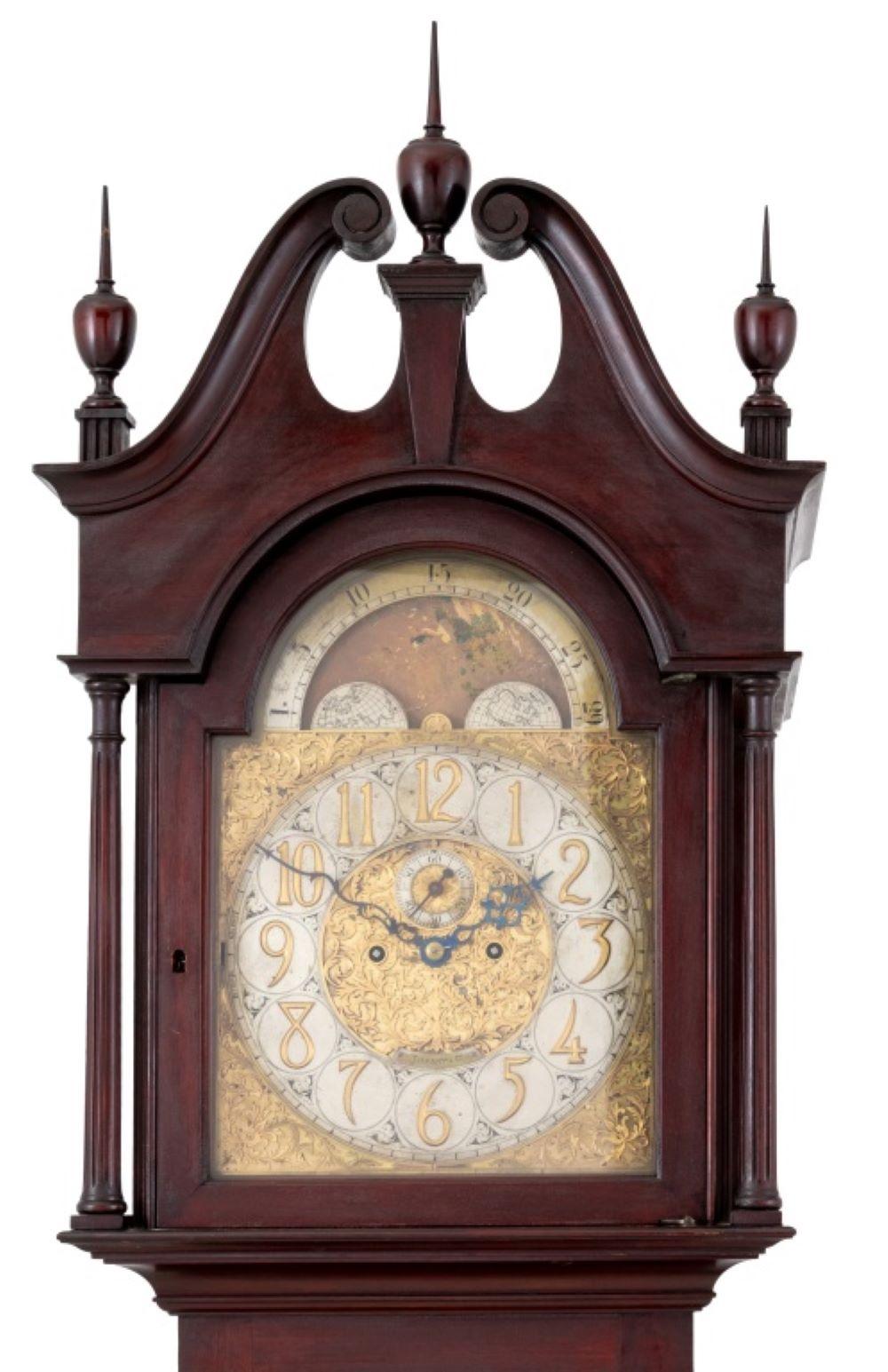George III Style Mahogany Longcase Clock, retailed by Tiffany and Company, early 20th century, the hood with swan neck pediment, mounted with finials, enclosing a cut brass dial with moon phase aperture and second dial, the movement strike on gong,