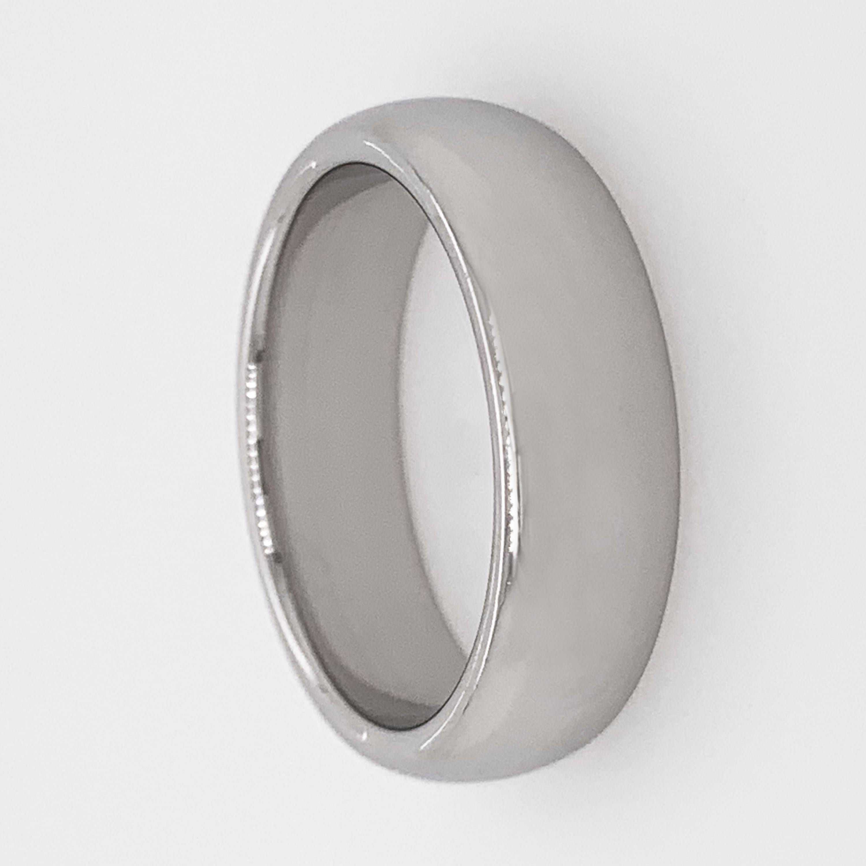 This simple but elegant Tiffany & Co. curved platinum band is the perfect choice for a man who wants a designer wedding ring without seeming too flashy.  

6mm wide.
Size 7.5 (55 EU)
14.45 grams.
Signed Tiffany&Co. 
