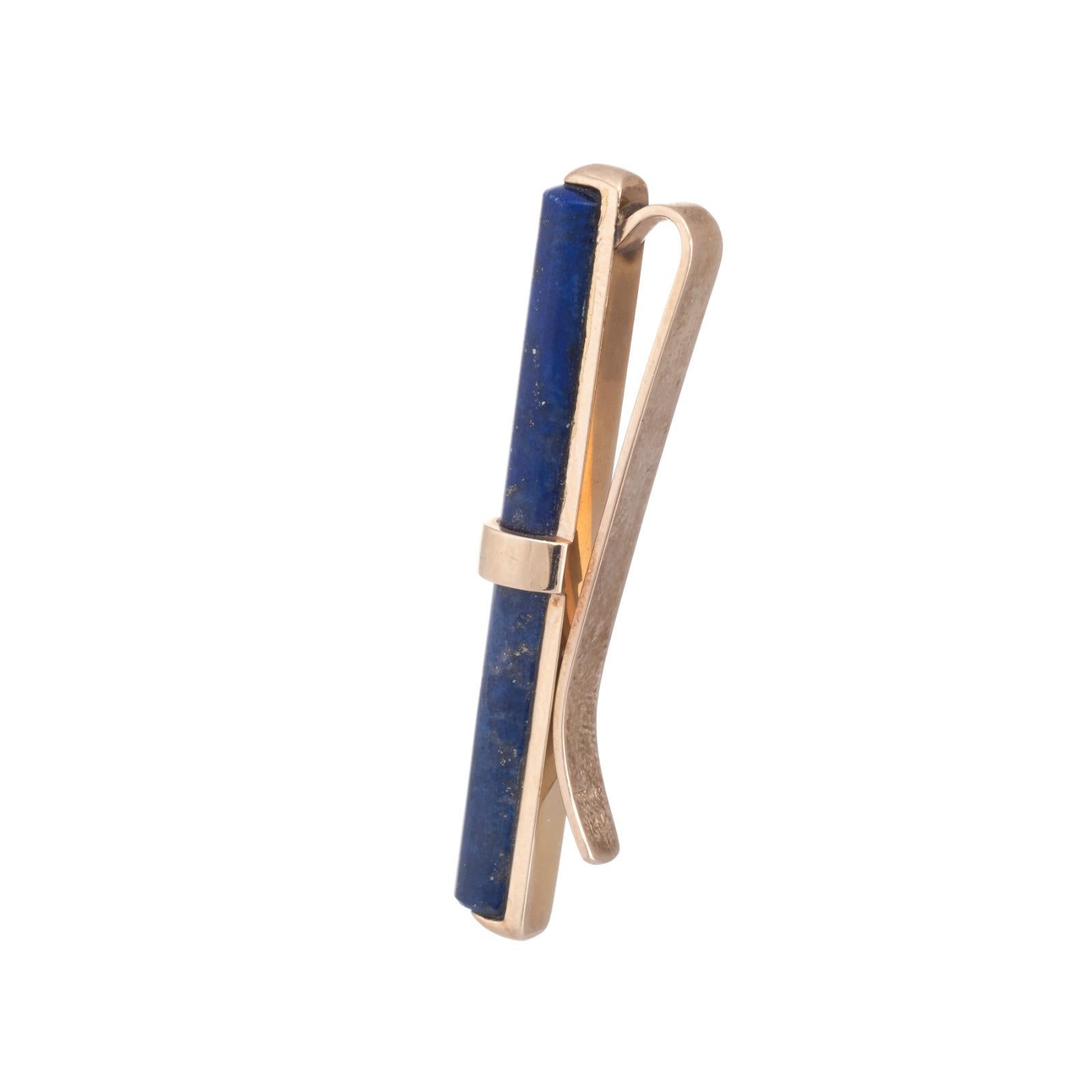 Elegant Tiffany & Co tie clasp (or money clip), crafted in 14k yellow gold. 

Lapis Lazuli measures 20mm x 5mm (two separate sections). The lapis is in excellent condition and free of cracks or chips.  

A versatile piece that can be worn as a tie