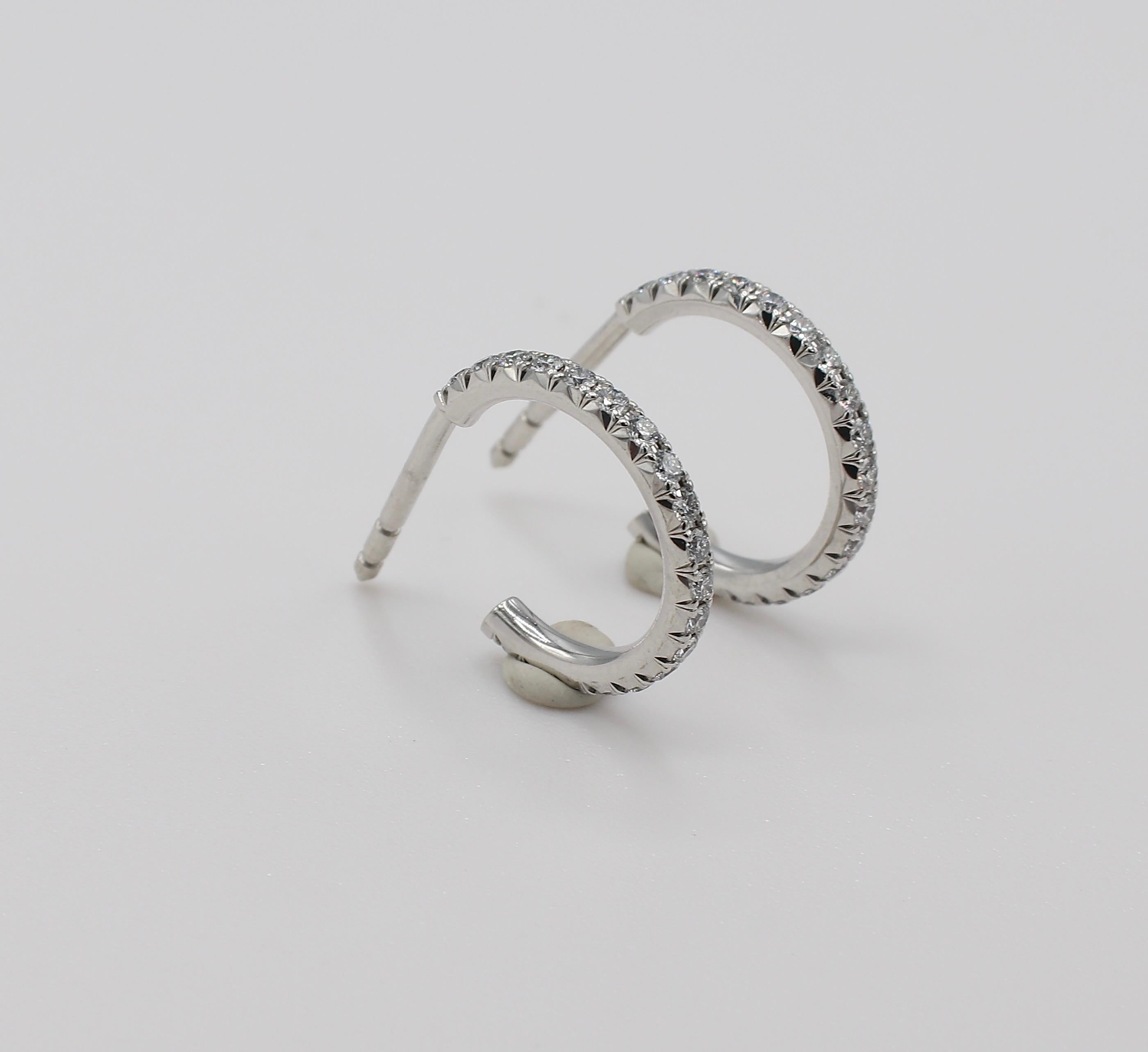 Tiffany & Co. Metro 18K White Gold Diamond Hoop Earrings Small Size 

Metal: 18k white gold
Weight: 1.93 grams
Diamonds: Approx. 0.30 CTW G VS
Diameter: 14MM
Width: 1.7MM
Retail: $3,200

