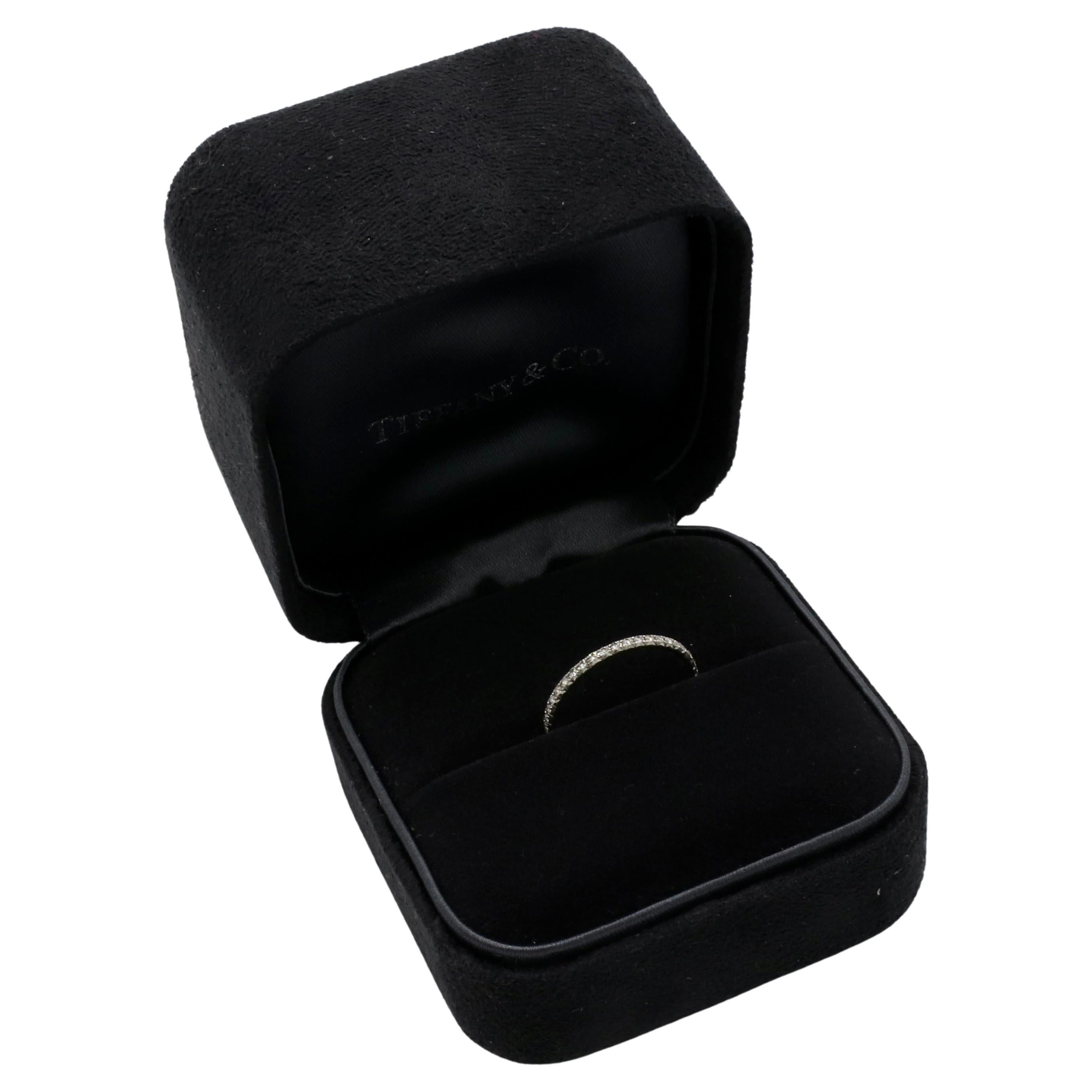 Tiffany & Co. Metro .20 Carat Natural Round Diamond Full Eternity Band Ring 
Metal: 18k white gold
Weight: 1.08 grams
Size: 6 (US)
Width: 1.5mm
Signed: ©Tiffany & Co. Au750 BELGIUM
Diamonds: 0.20 CTW D-F VVS round natural diamonds
Retail: $2,800