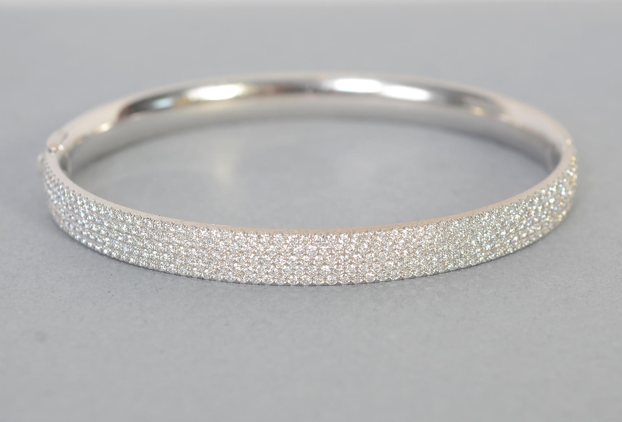 Tiffany Metro hinged bangle bracelet with five rows of round brilliant diamonds weighing just under 2 carats. The bracelet is 18 karat white gold. 
It is 2 1/2 inches in diameter and 1/4 inch in height. It is the medium size.
The bracelet is