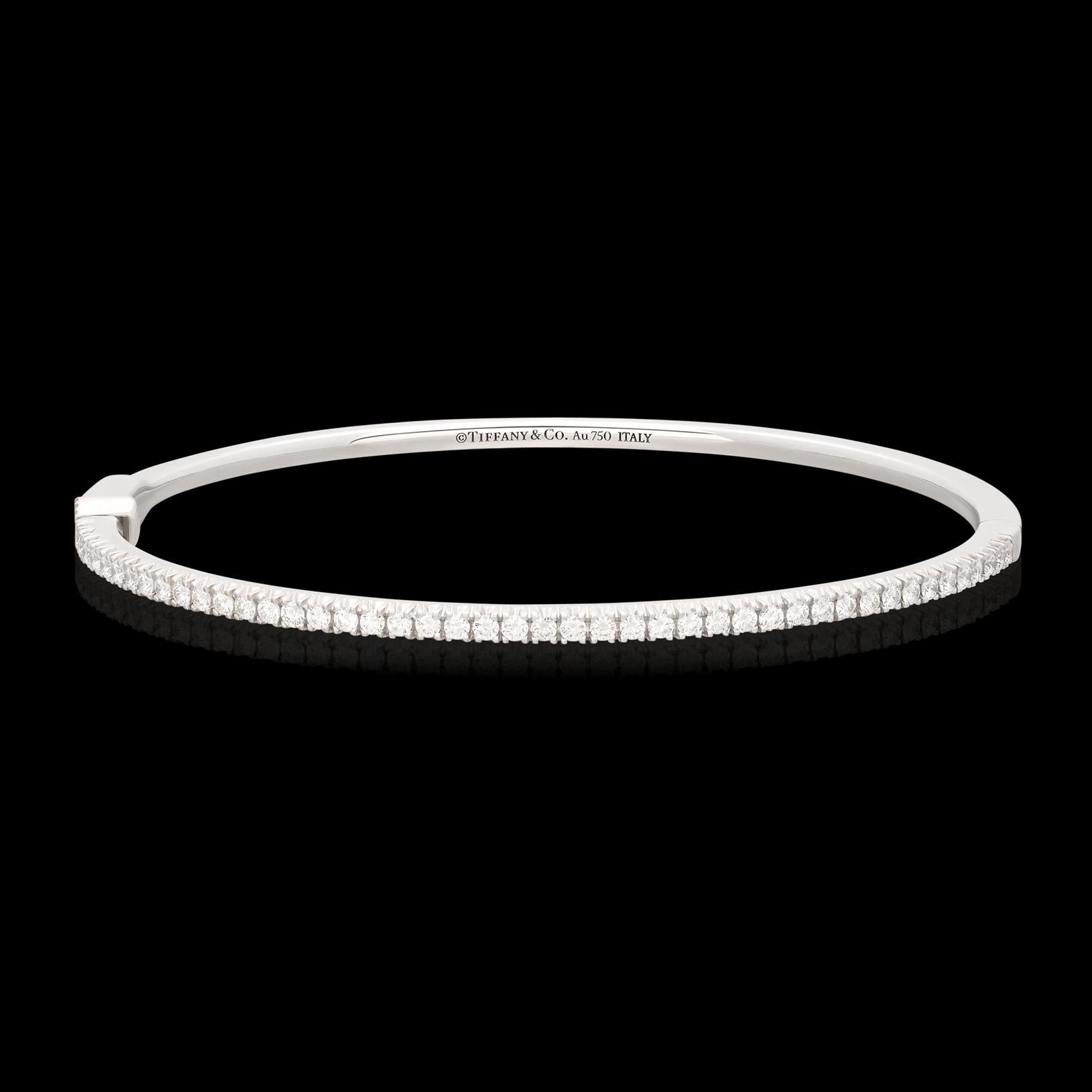 From one of the finest names in jewelry comes the Metro Diamond Bangle Bracelet by Tiffany & Co. Made with the finest quality and materials that you'd expect from Tiffany jewelry, this stunning bangle bracelet with a hook lock hinge features 45