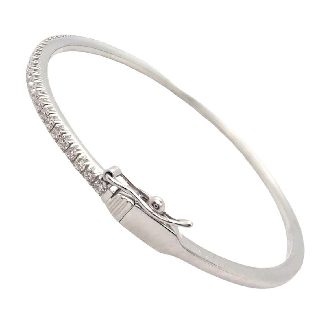 18k White Gold Diamond Hinged Metro Bangle Bracelet by Tiffany & Co.
The streamlined sparkle of this design captures cosmopolitan style and energy. Hinged bangle in 18k white gold with a half circle of round brilliant diamonds. Large size, fits