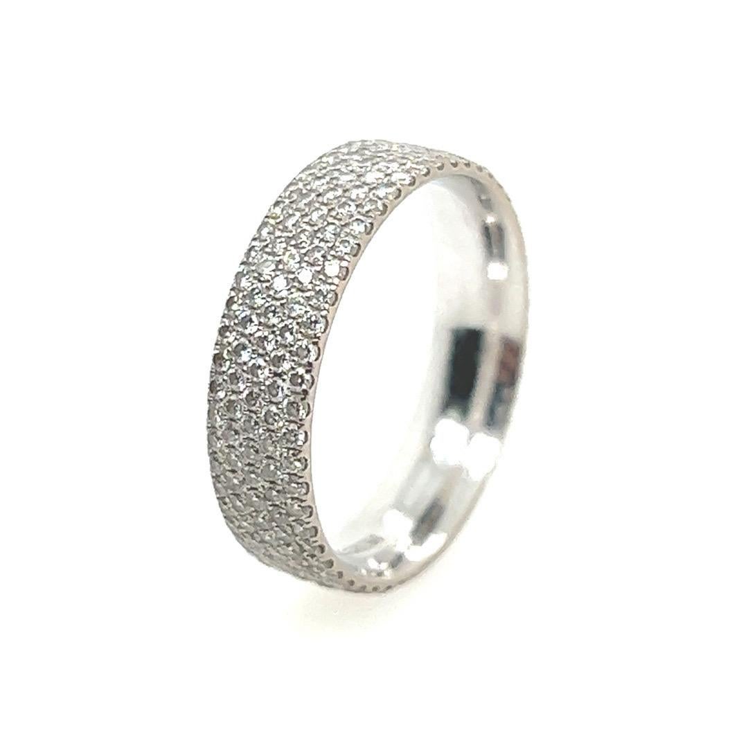 A magnificent authentic Tiffany & Co diamond eternity band. The piece is a size 6 and contains approximately 245 Natural Colorless Round Brilliant Diamonds all around. The Hallmark is stamped “Tiffany&Co Au 750 Belgium” and includes an original