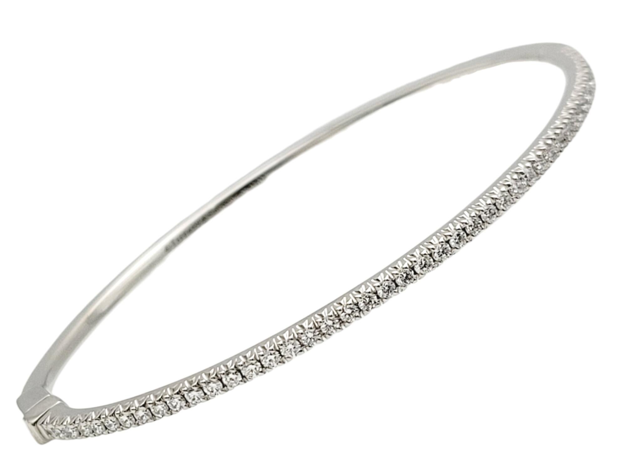 This gorgeous Tiffany & Co. diamond bangle bracelet is a stunning piece from the renowned Tiffany Metro Collection. This bangle exudes a streamlined, modern design reminiscent of a twinkling nighttime city skyline. It is the epitome of elegance,