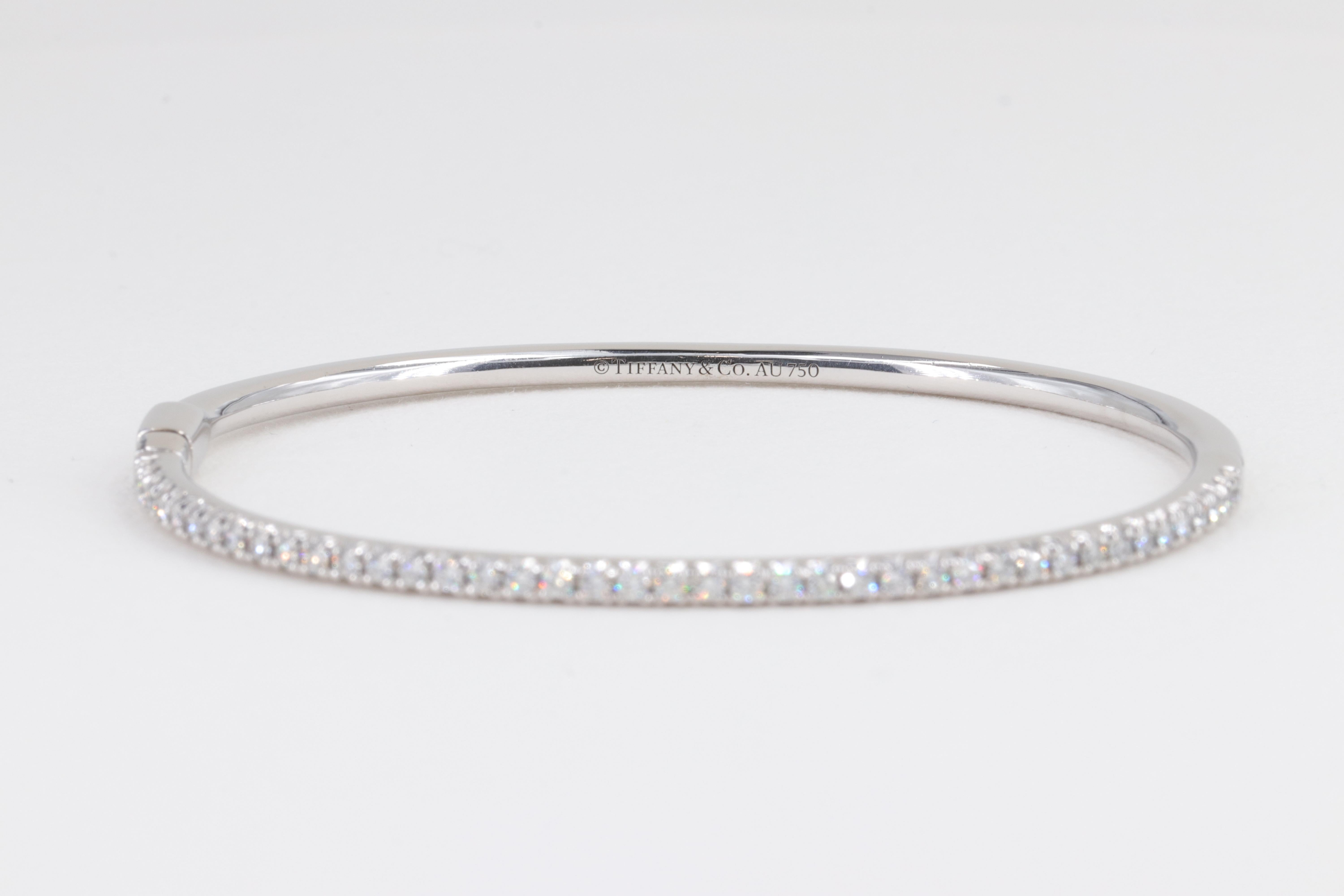 Tiffany & Co. Metro Hinged Diamond and 18 Karat White Gold Bangle

Diamonds:

Diamonds - 41 = 0.61ctw
Color - D-F
Clarity - VS+

Bracelet:

Metal - 18 Karat White Gold 
Weight - 12.3 Grams