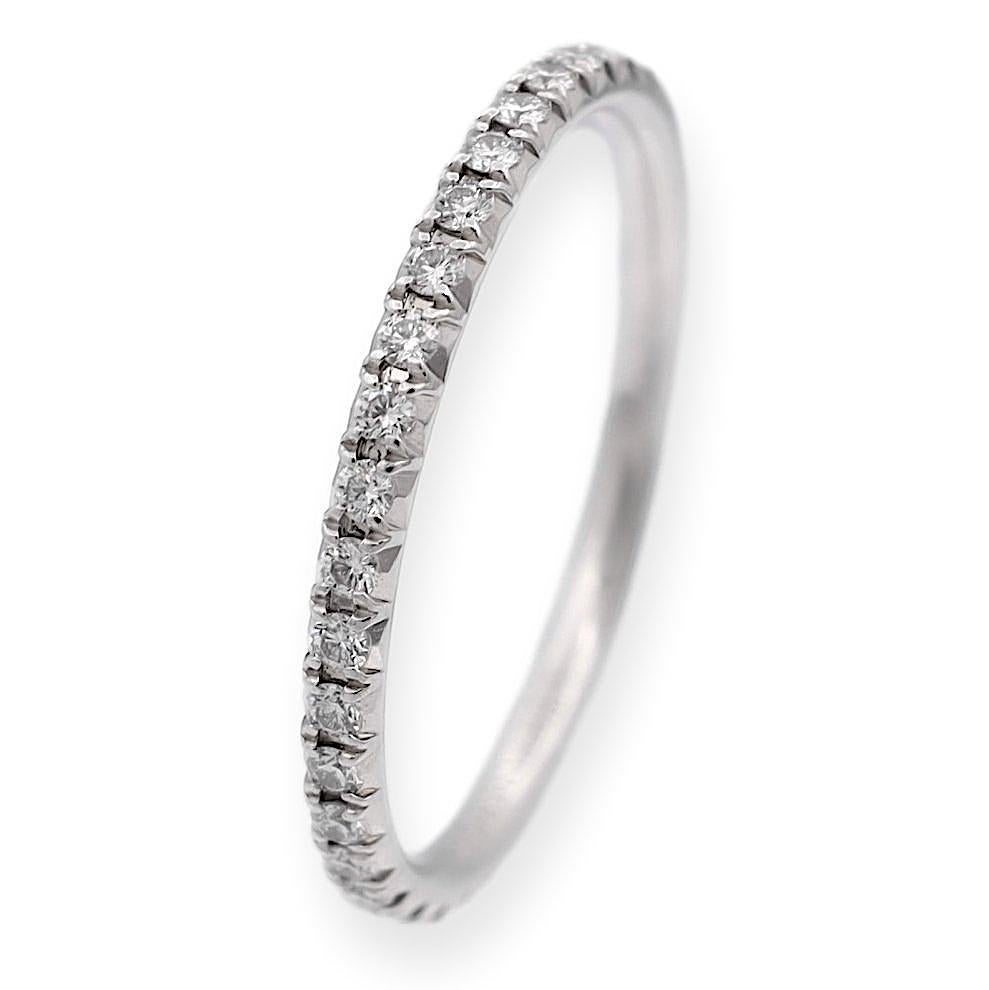 Tiffany & Co. Metro band ring, meticulously crafted in platinum, showcasing a continuous row of round brilliant cut diamonds, totaling 0.18 carats, encircling the band in a captivating 
