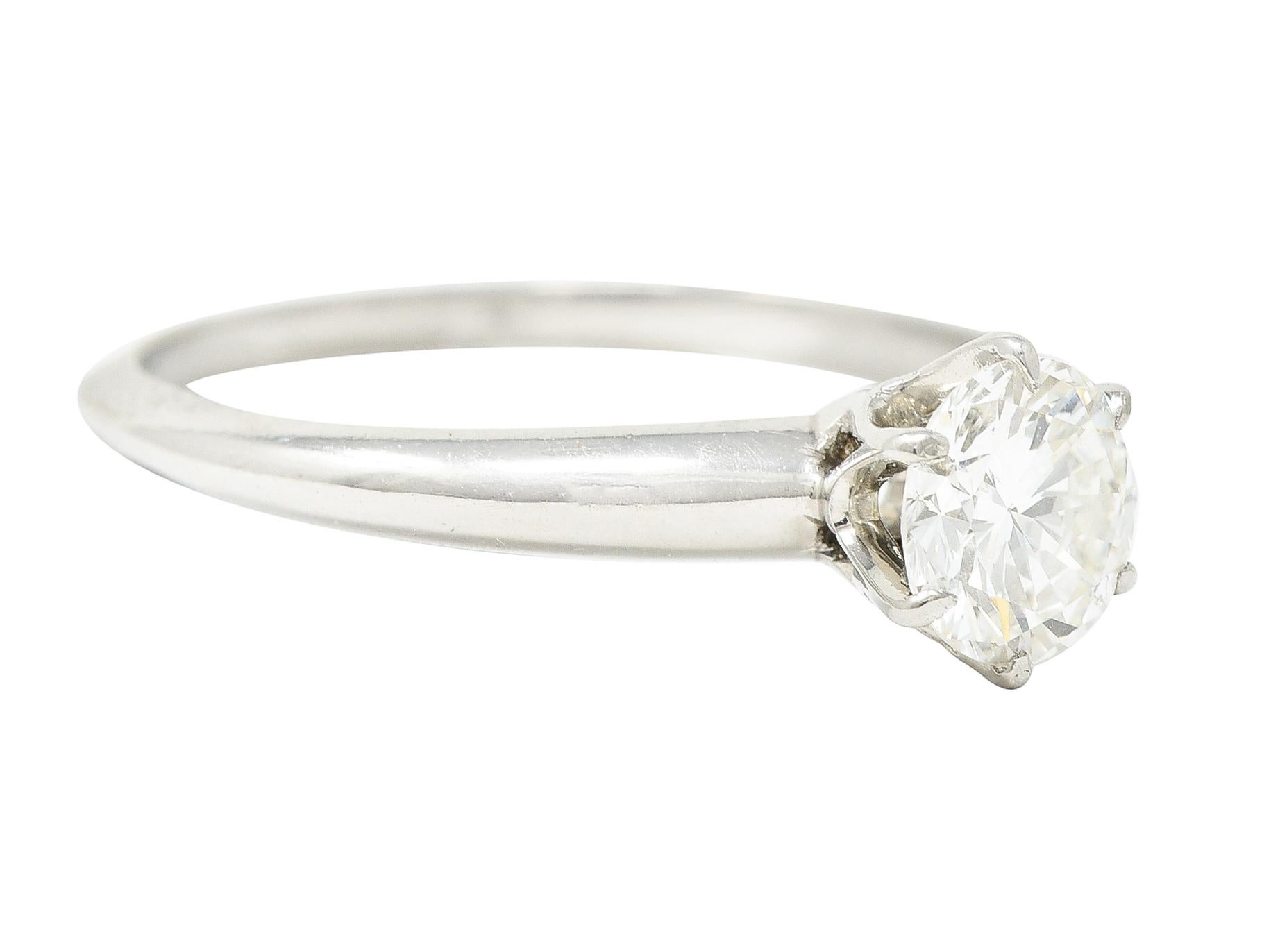 Centering a transitional cut diamond weighing approximately 0.60 carat total - H color with SI1 clarity. Prong set in a classic 6 prong Tiffany style setting. With knife edge shank. Stamped for platinum. Circa: 1950's. Ring size: 5 and sizable.