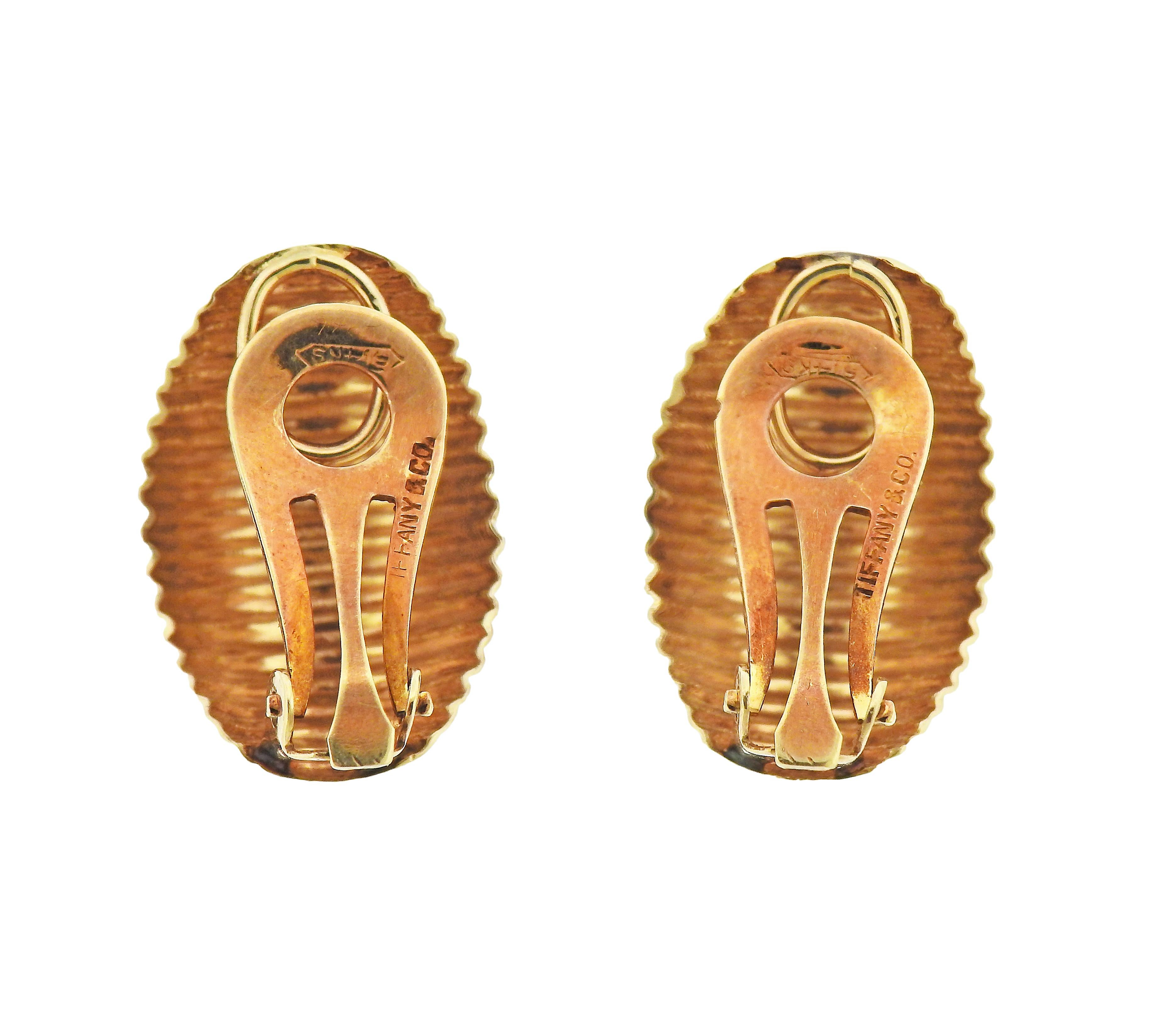 Pair of mid century 14k gold half hoop earrings by Tiffany & Co. Earring measure 22mm x 15mm. Marked: Tiffany & Co, 14k. Weight - 6.2 grams.