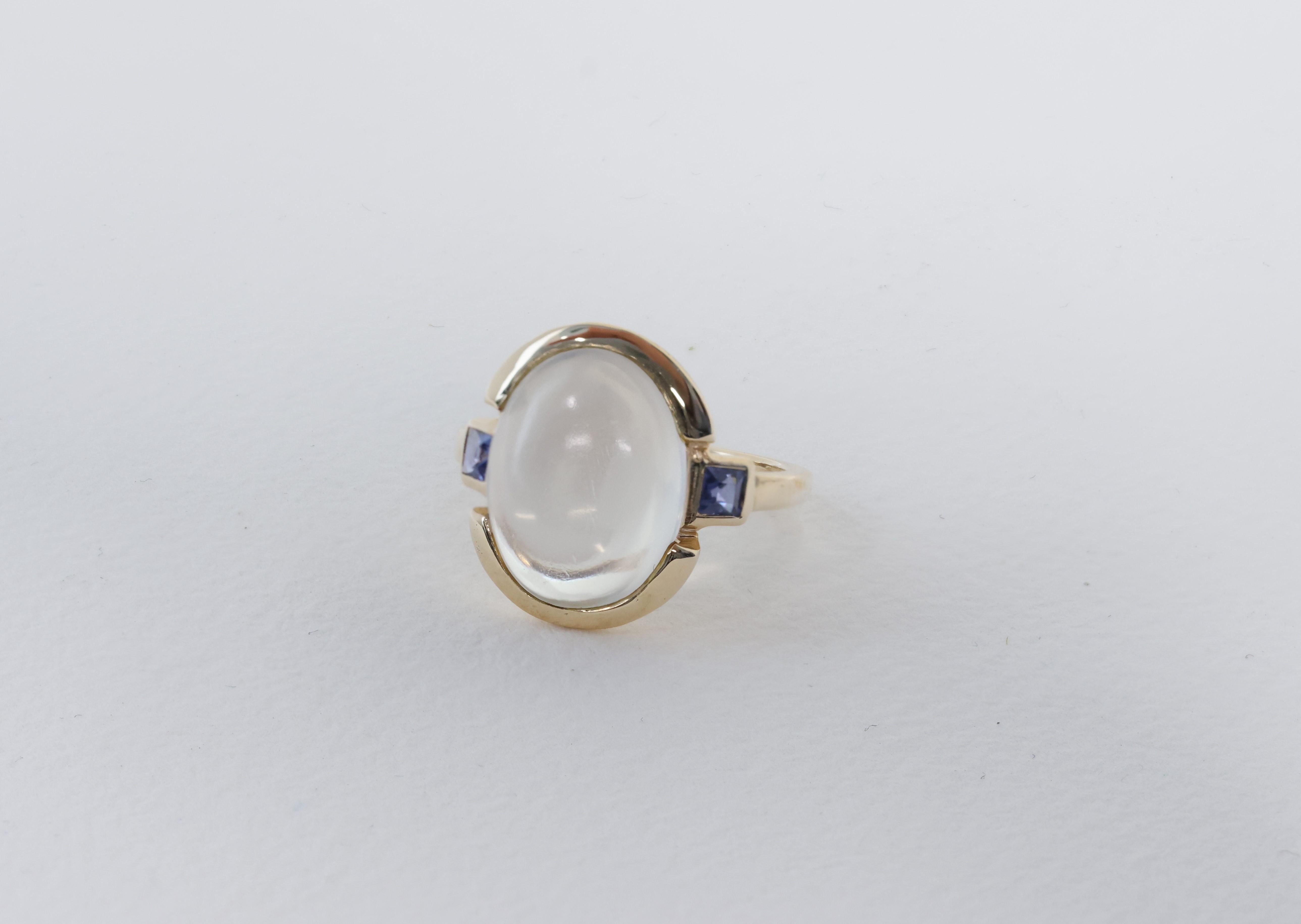 Circa 1950s, 14k, Tiffany & Co. This fabulous fifties ring by Tiffany & Co. is set with a fine 4.50 carat moonstone framed by two vibrant sapphires (.35 carat total). The moonstone’s luminescent appearance and delicate chatoyancy give it