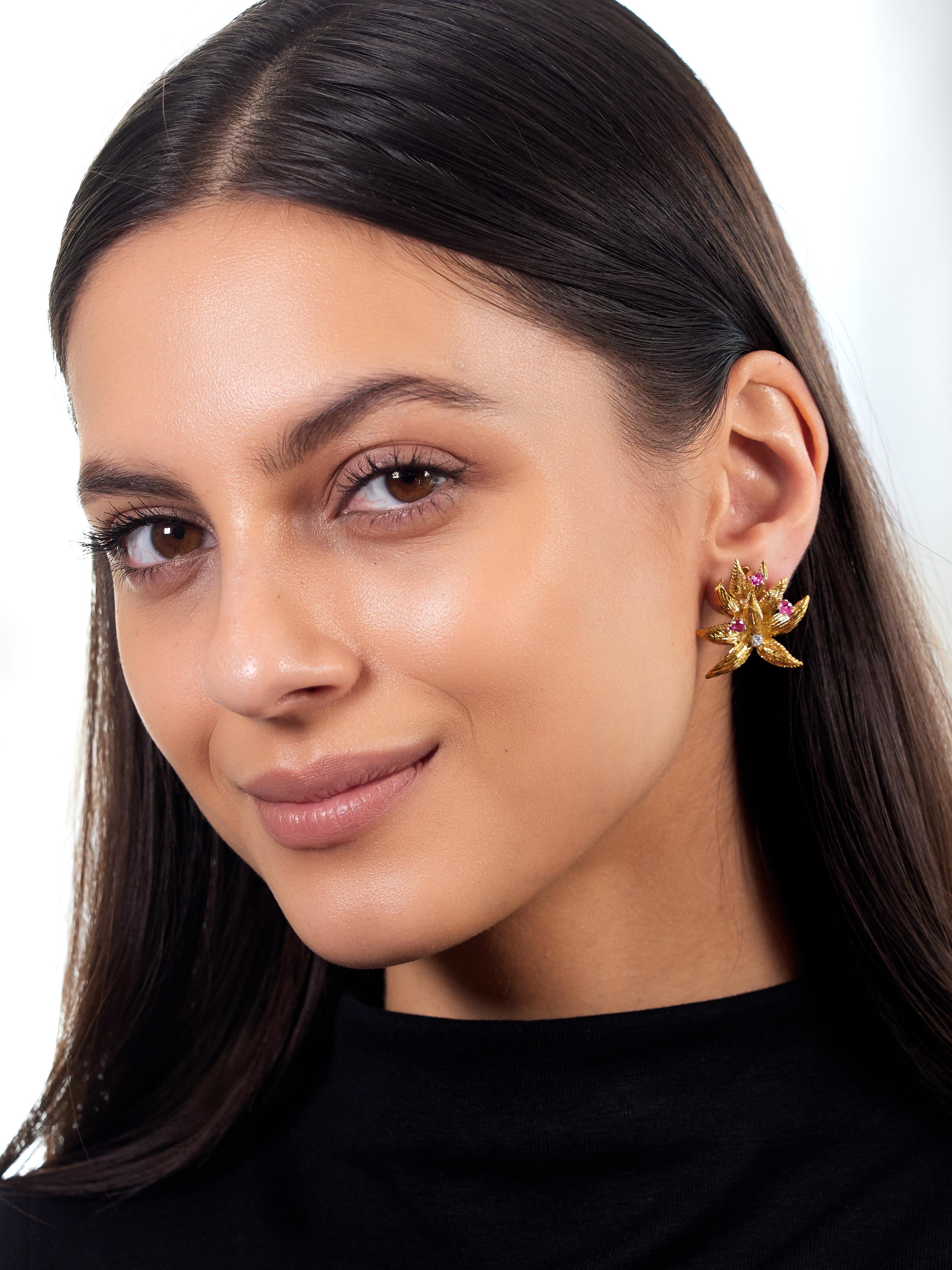 Designed as dimensional yellow gold leaves arranged as burst motif
Engraved with texture and leaf veining - prong set with rubies
Round cut and weighing approximately 0.84 carat total
Transparent bright medium red in color - with diamond